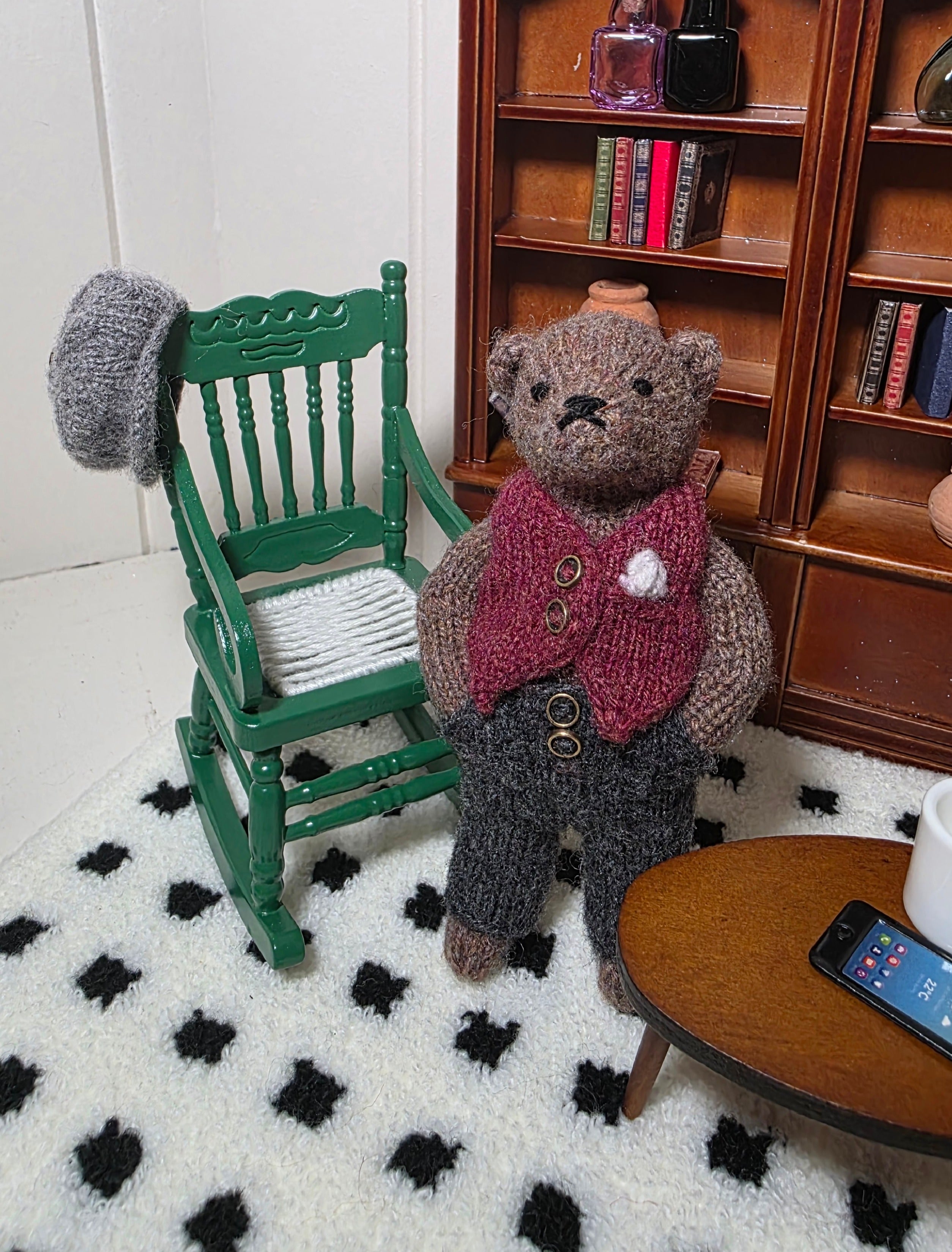 Small hand knitted bear with removeable clothes