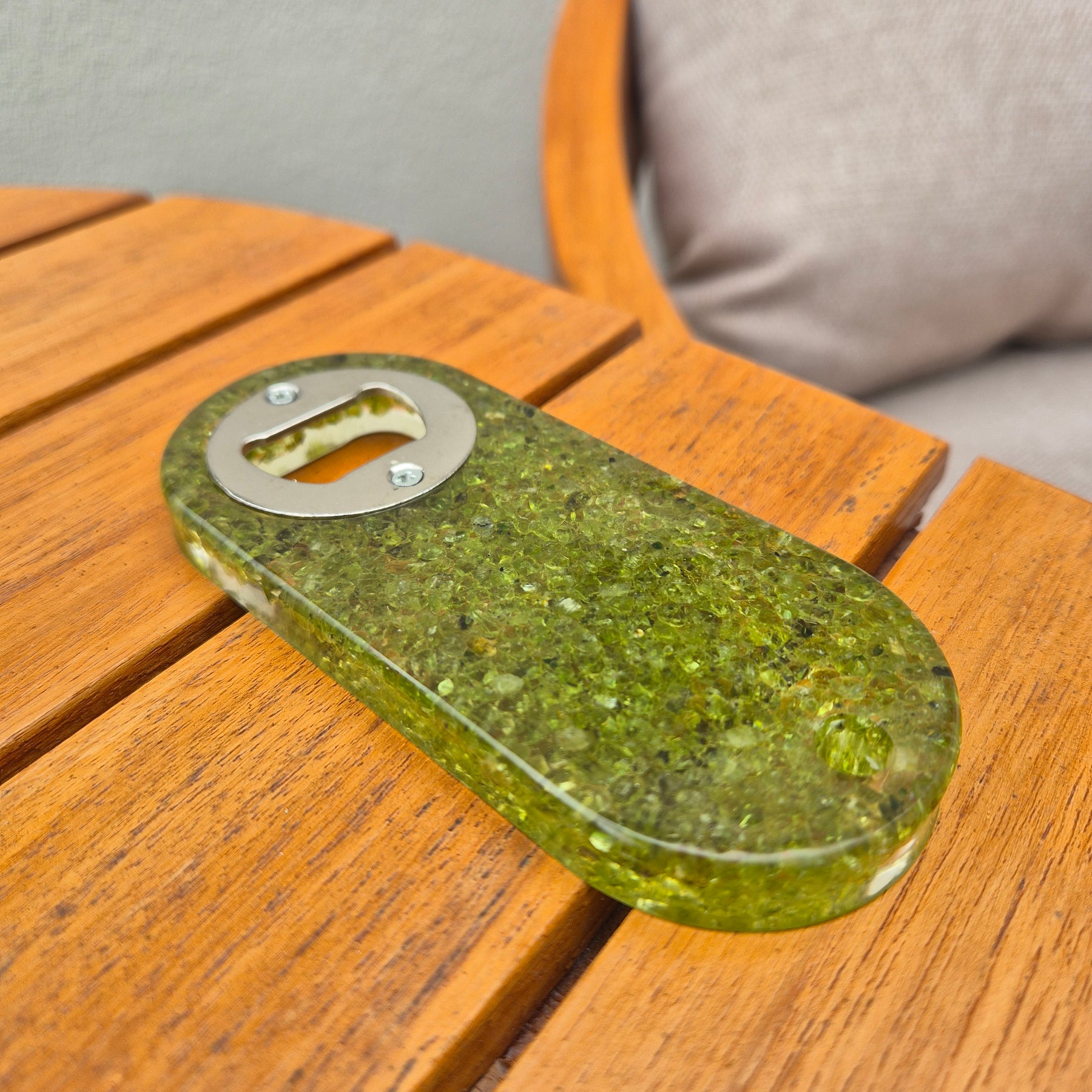 Resin bottle opener with inlaid peridot stones