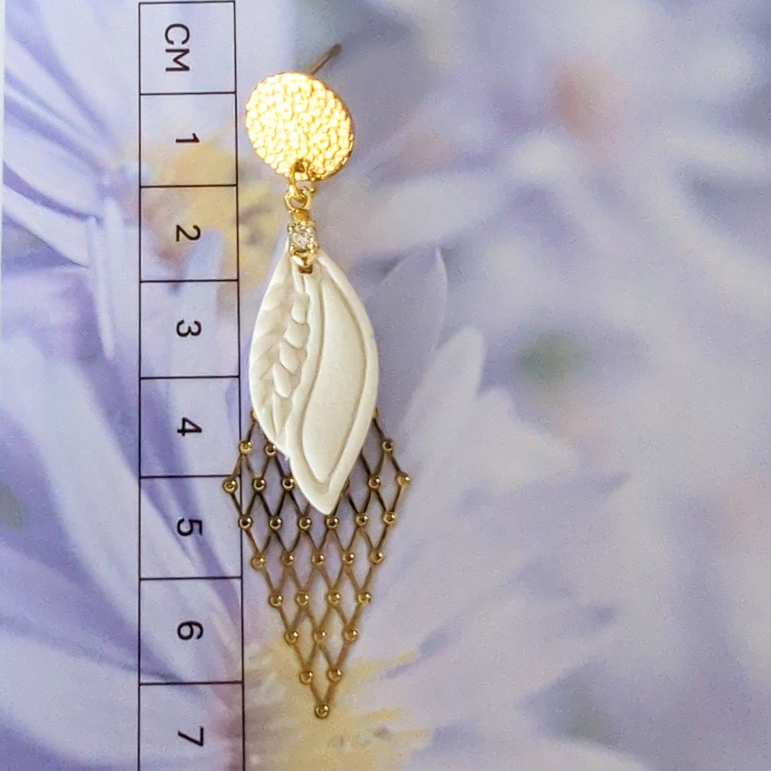White Earrings With Gold Findings in Different Designs.