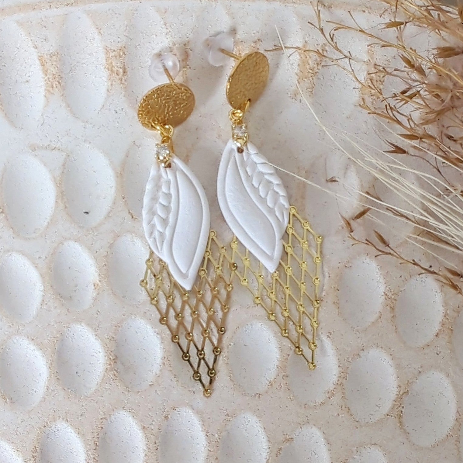 White Earrings With Gold Findings in Different Designs.