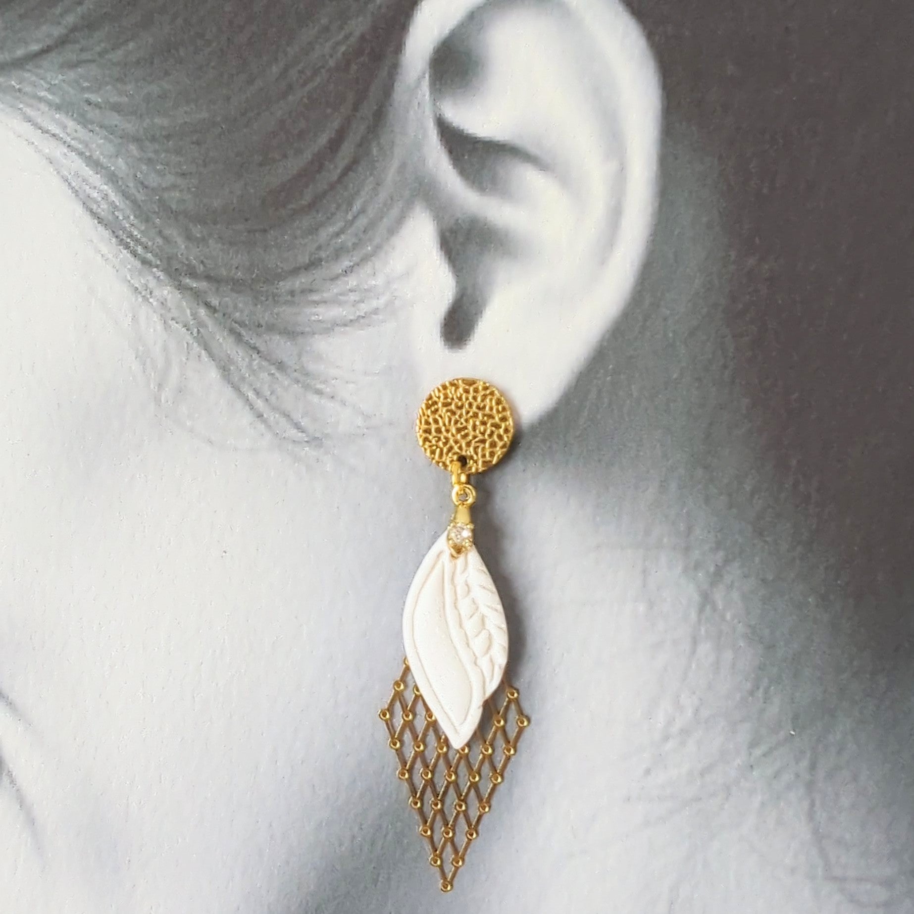 White Earrings With Gold Findings in Different Designs.
