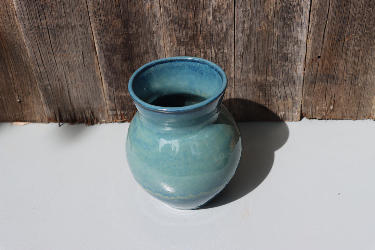 Large blue stoneware vase with blue green speckled glaze on buff clay