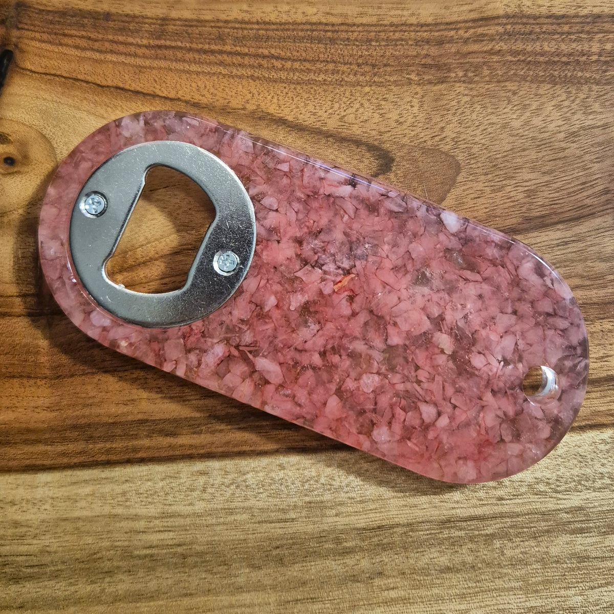 Resin bottle opener with inlaid rose quartz stones