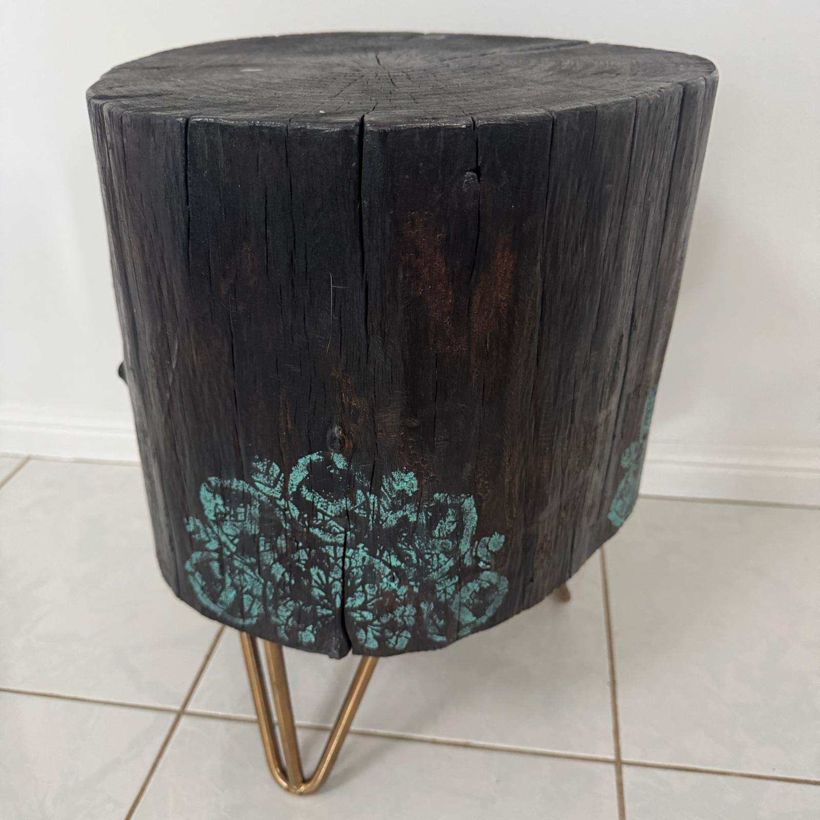 Timber stump table featuring teal mandala hand-painted artwork
