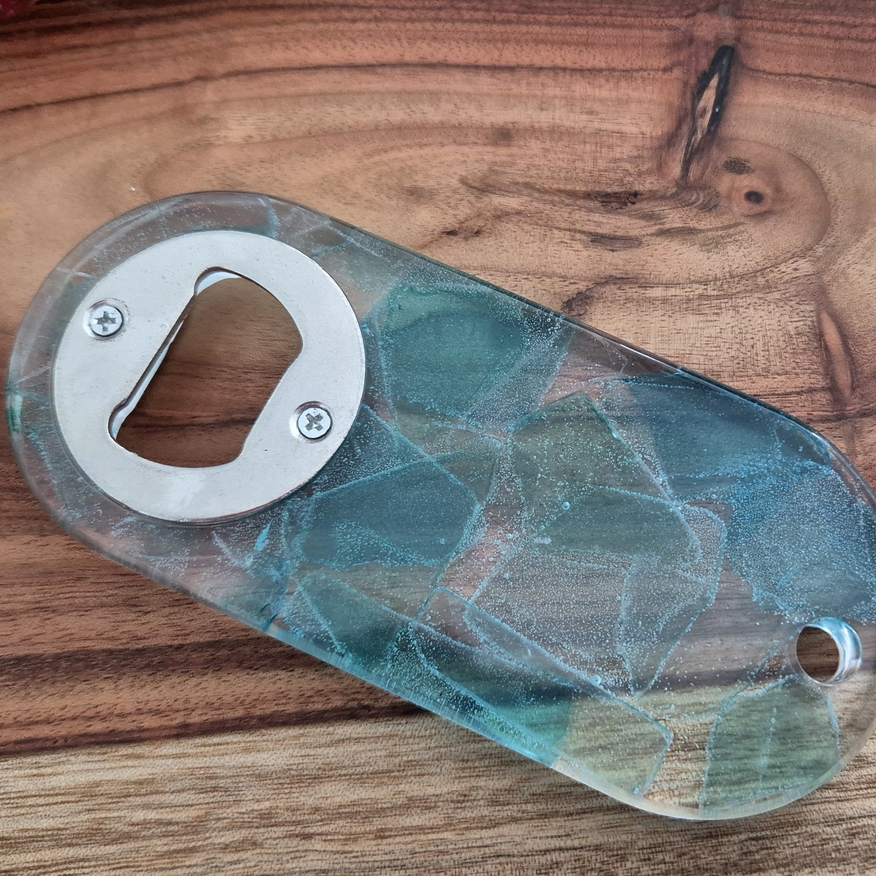 Resin bottle opener with inlaid sea glass