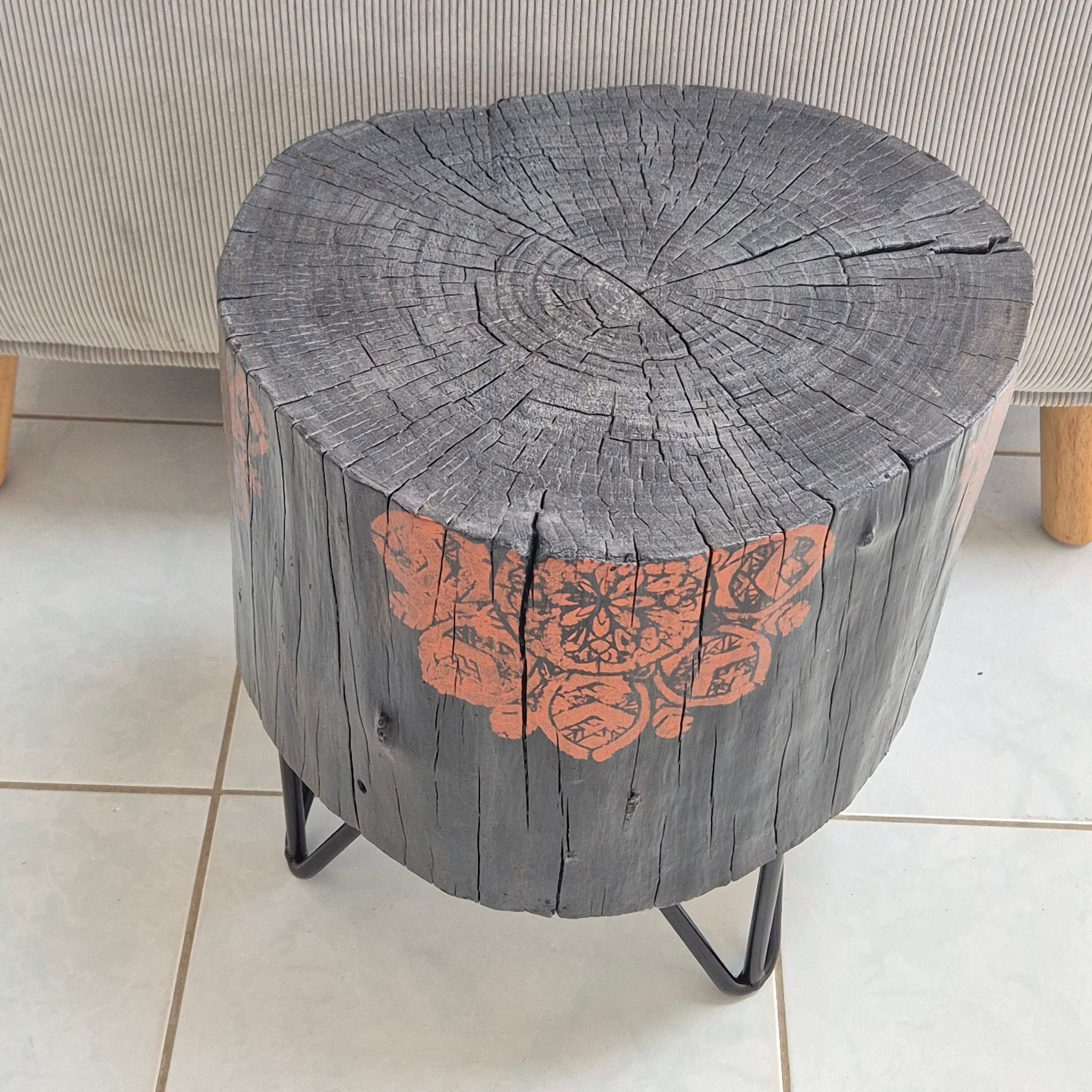 Burnt timber stump table featuring copper mandala artwork