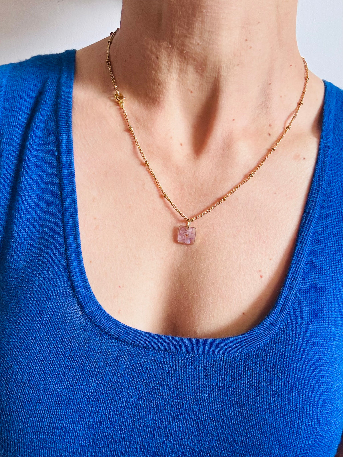 Gold plated resin necklace with purple wildflower