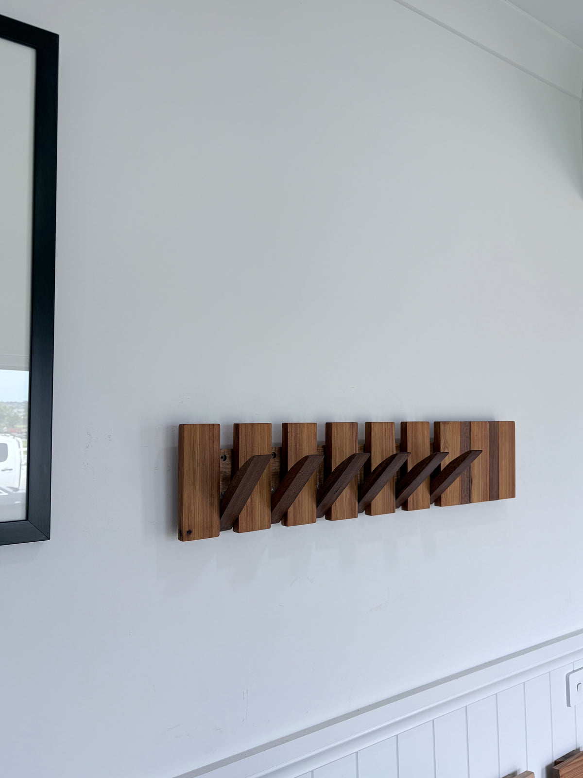 Two tone spotted gum and cypress horizon line piano style coatrack