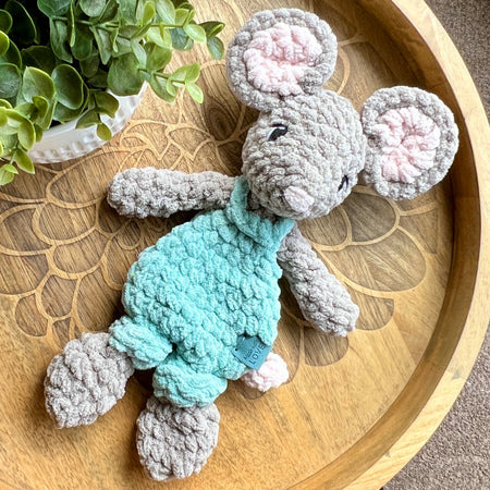 Handmade crochet Mini Mouse modern lovey in overalls with knotted legs.