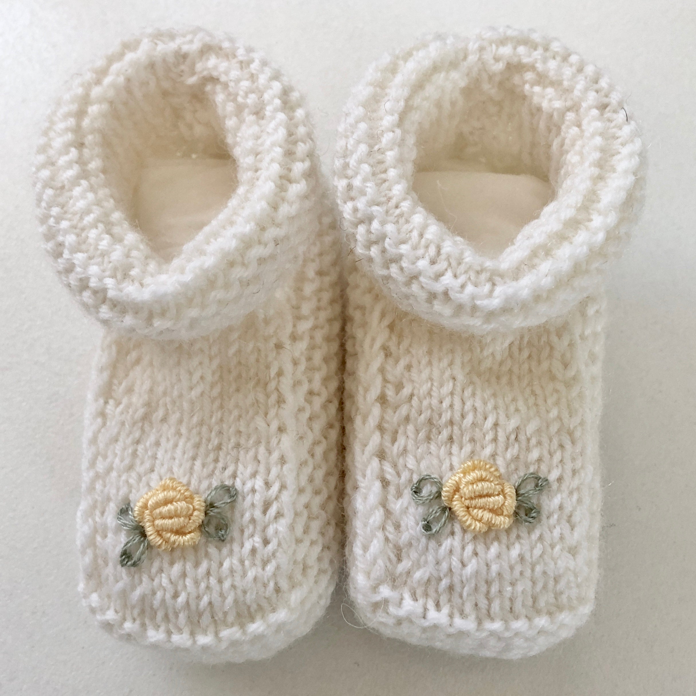 Hand-knitted baby booties with hand-embroidered rosebuds (Australian merino wool)