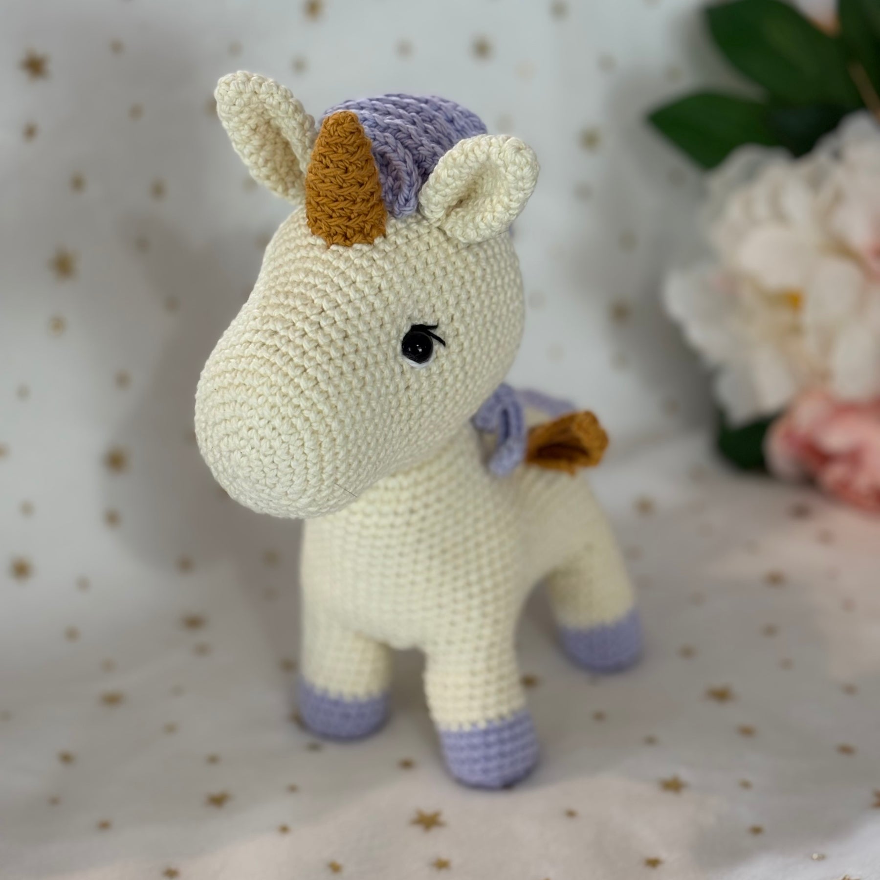 Crochet unicorn with golden wings