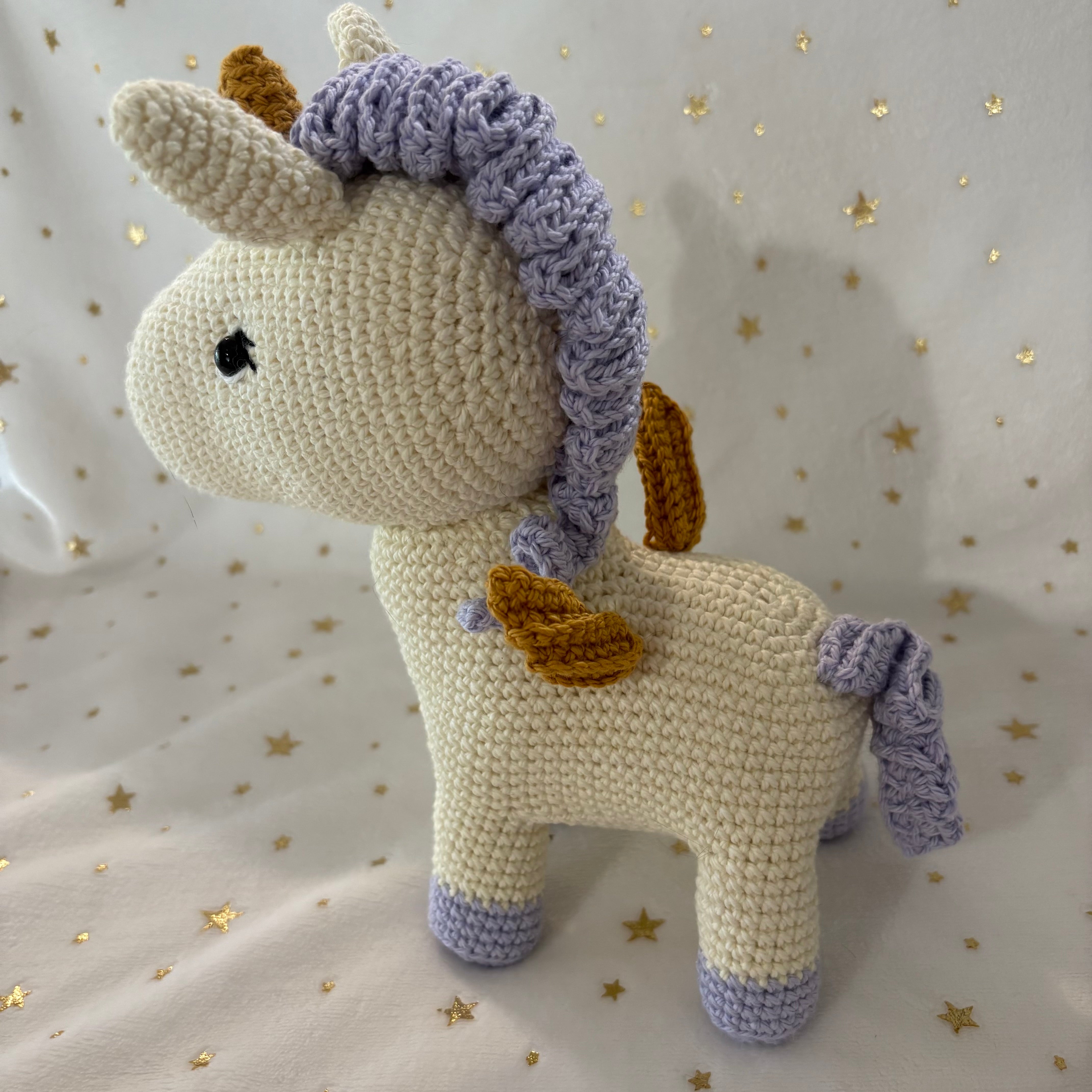Crochet unicorn with golden wings