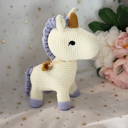 Crochet unicorn with golden wings