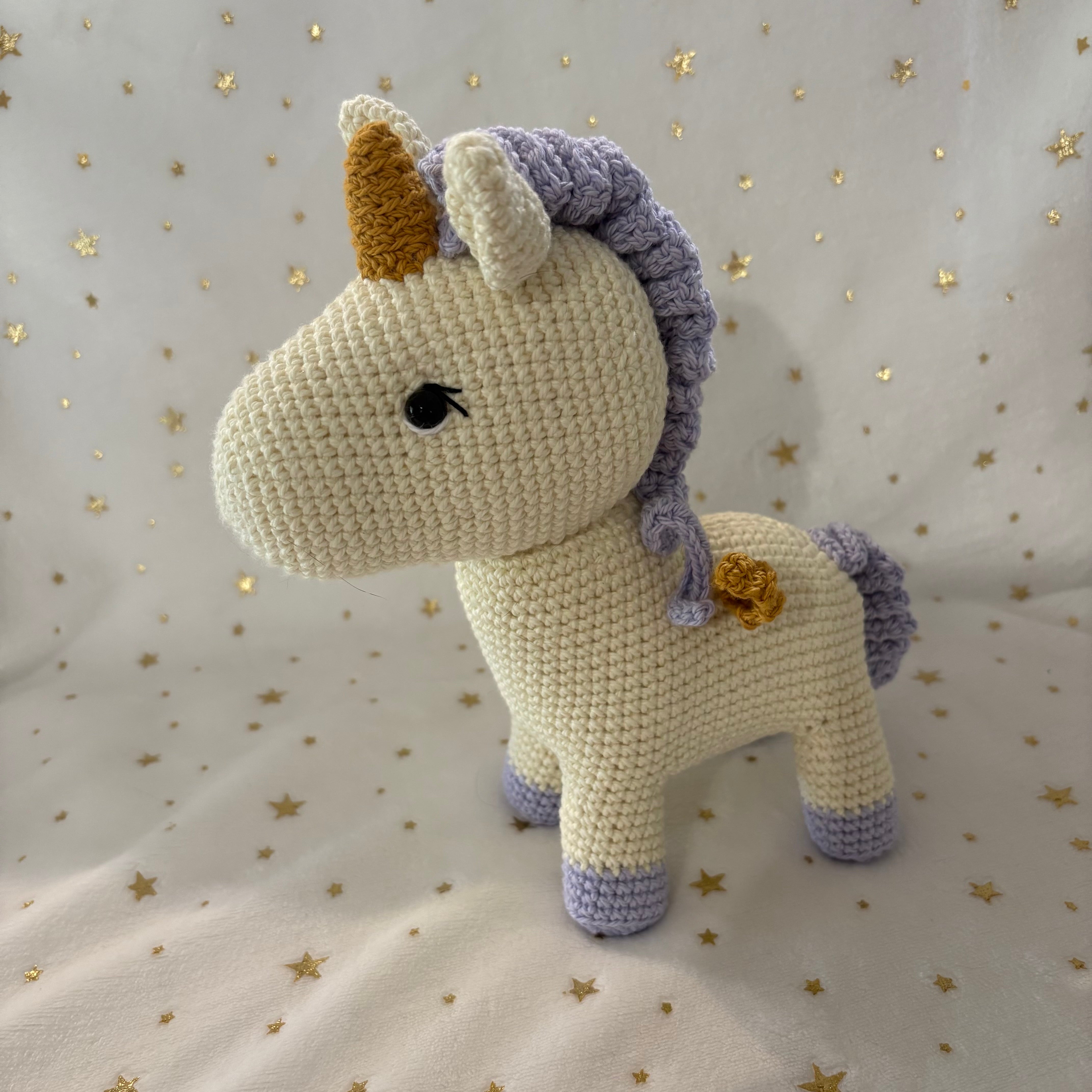 Crochet unicorn with golden wings