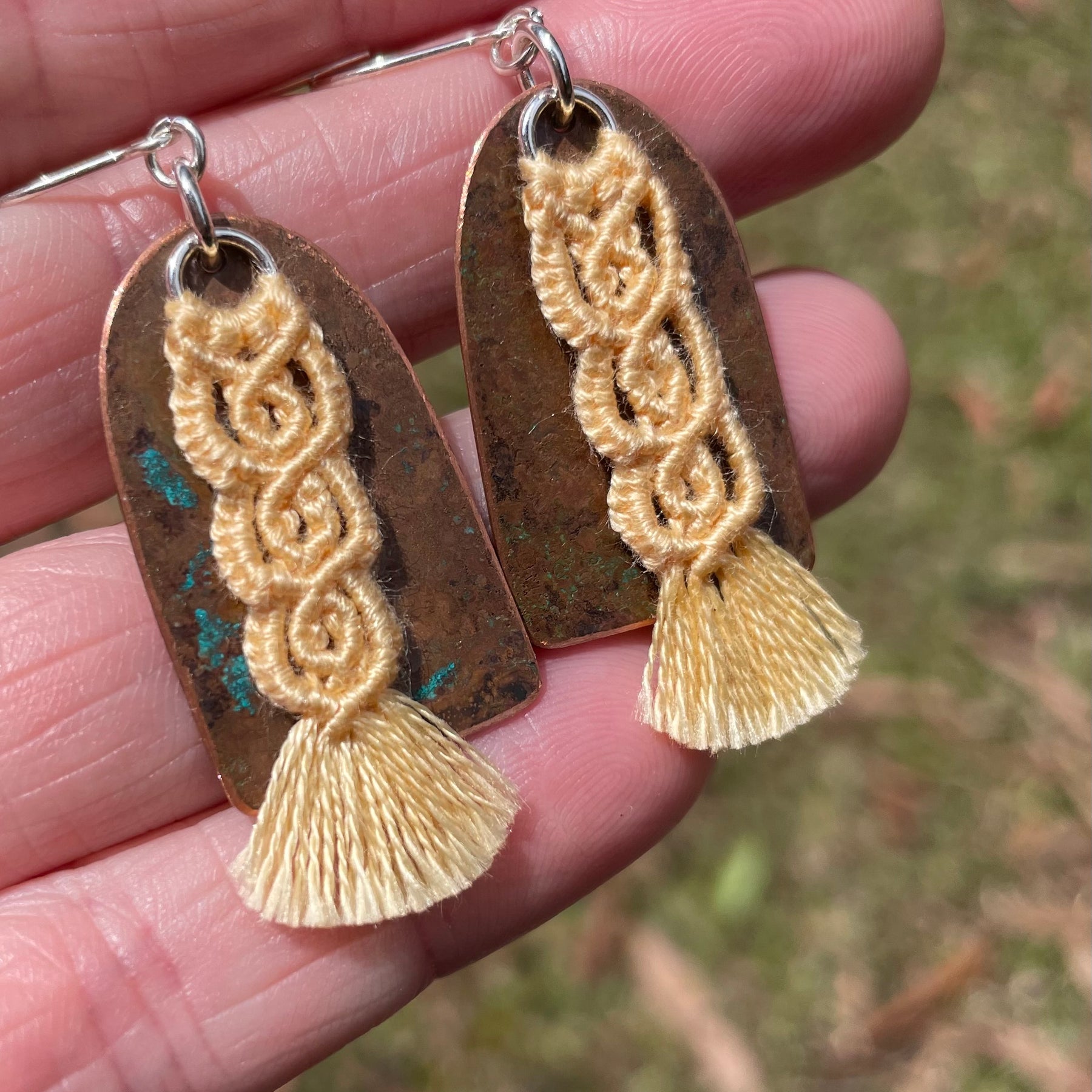Yellow macrame thread on patinated copper