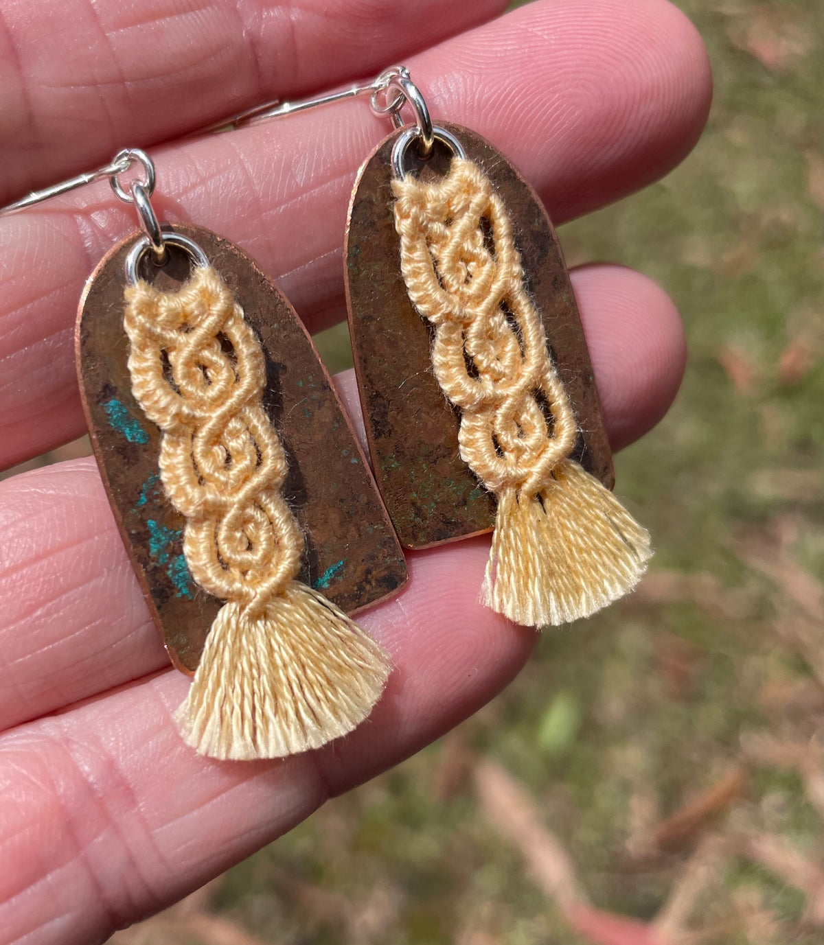 Yellow macrame thread on patinated copper