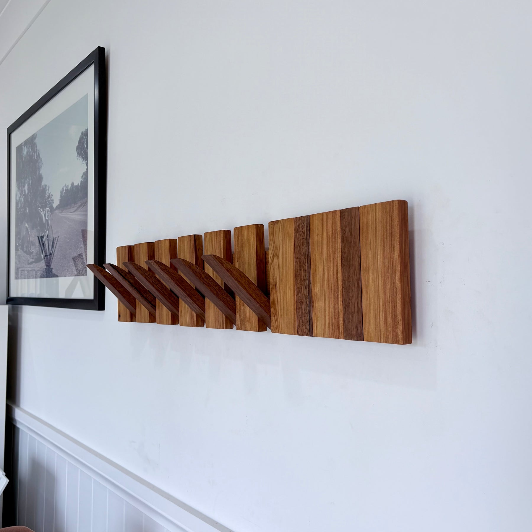 Two tone spotted gum and cypress horizon line piano style coatrack