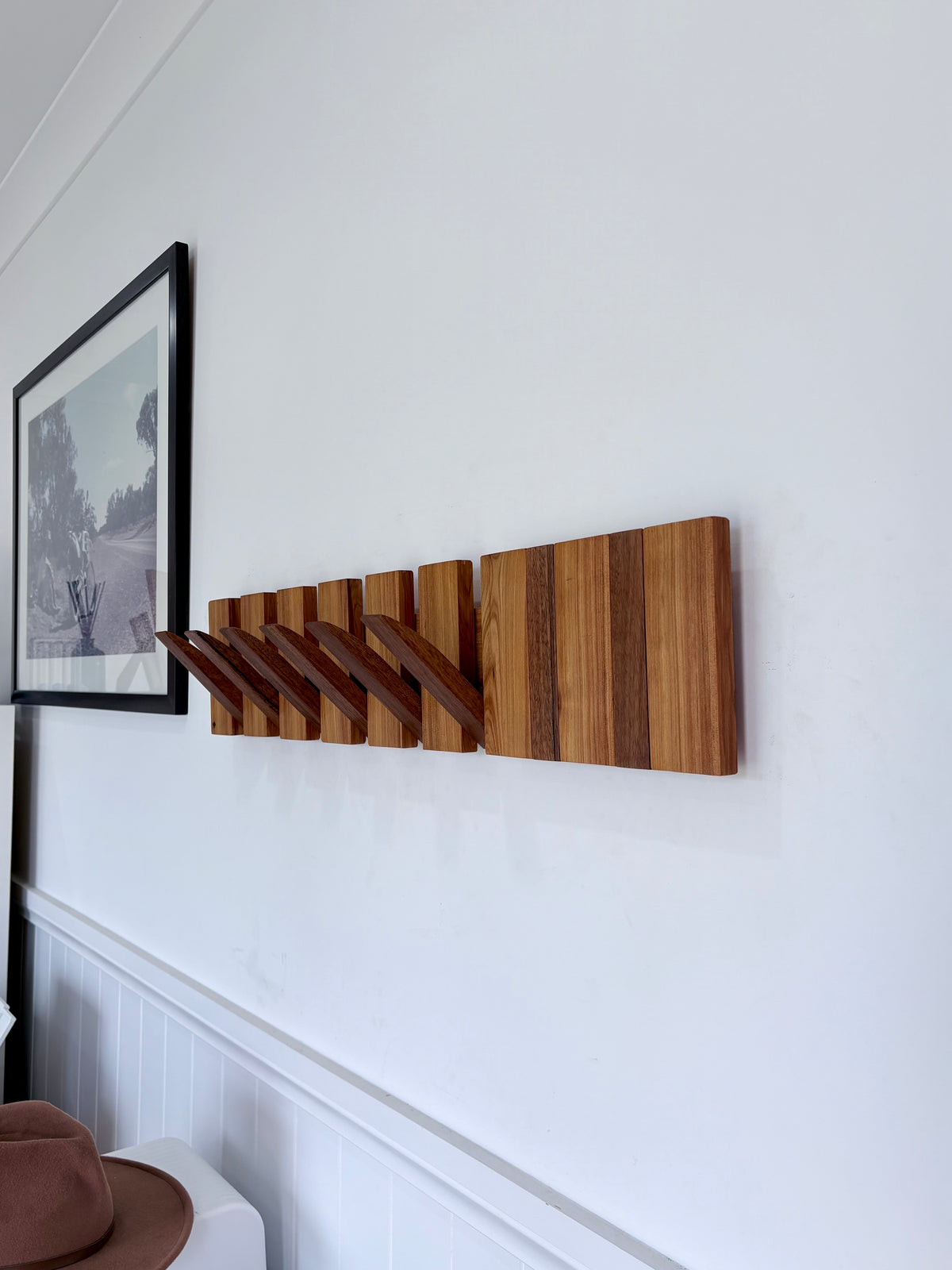Two tone spotted gum and cypress horizon line piano style coatrack