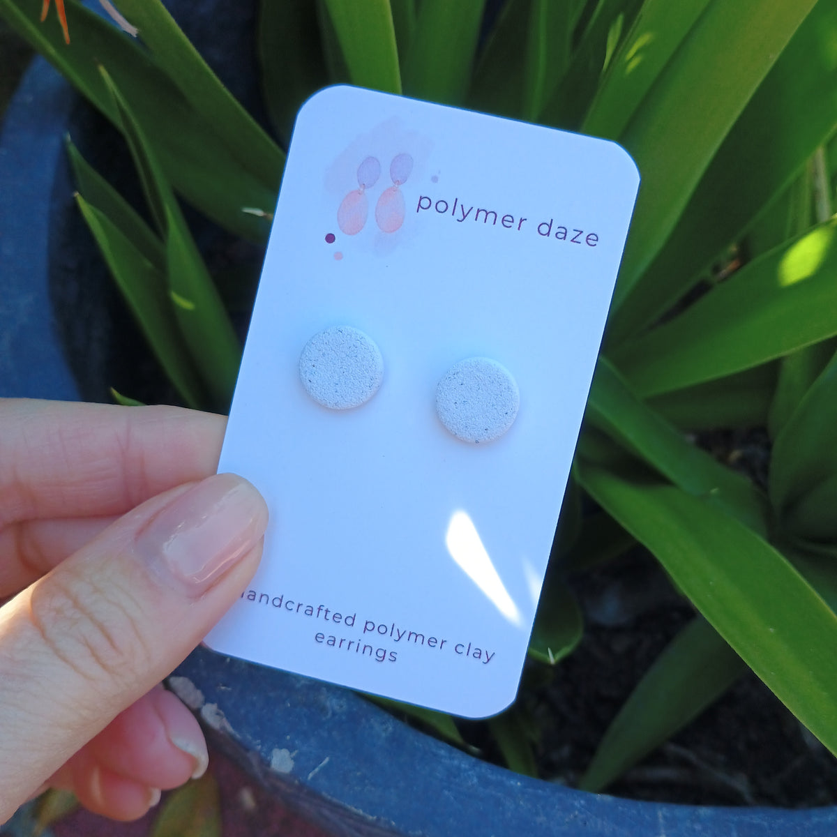 White sandy stud earrings