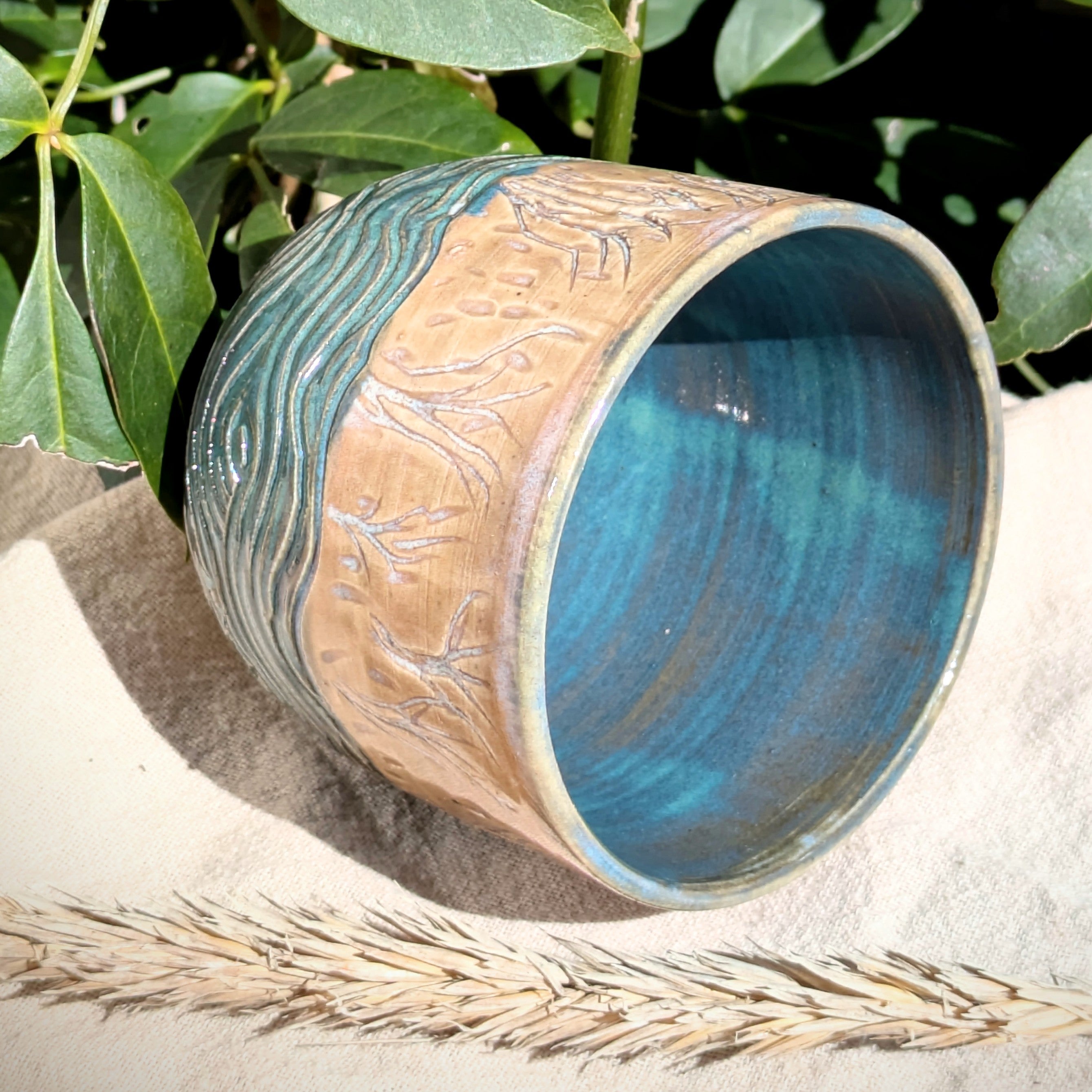 Sand dunes reeds and water tumbler