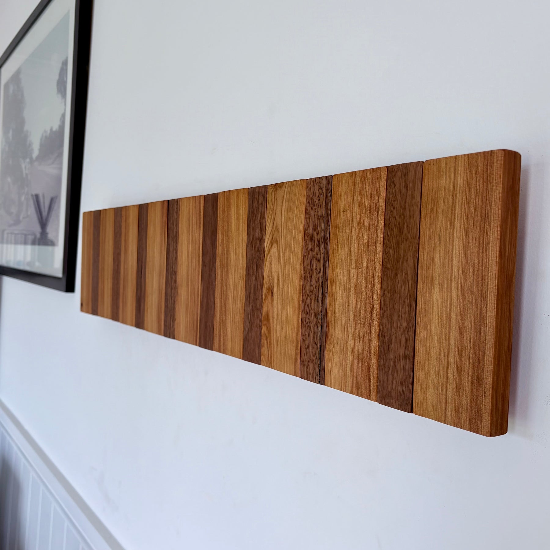 Two tone spotted gum and cypress horizon line piano style coatrack