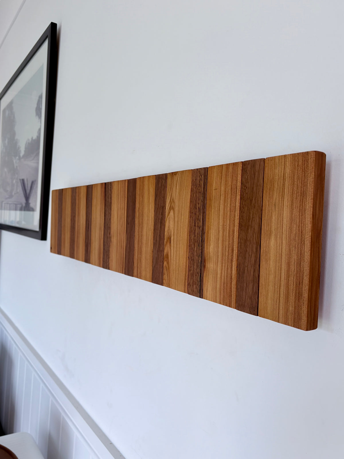 Two tone spotted gum and cypress horizon line piano style coatrack
