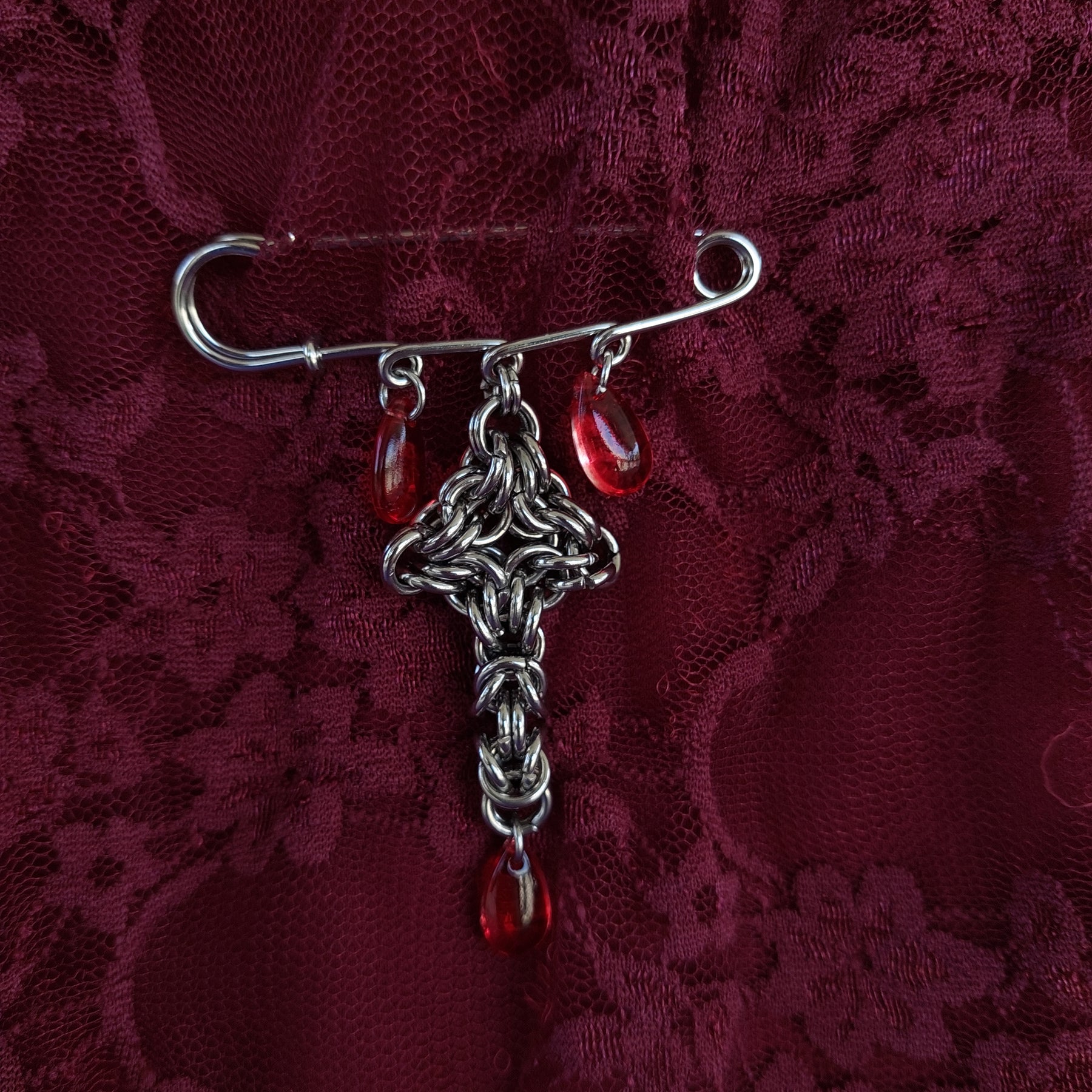 Bleeding cross brooch