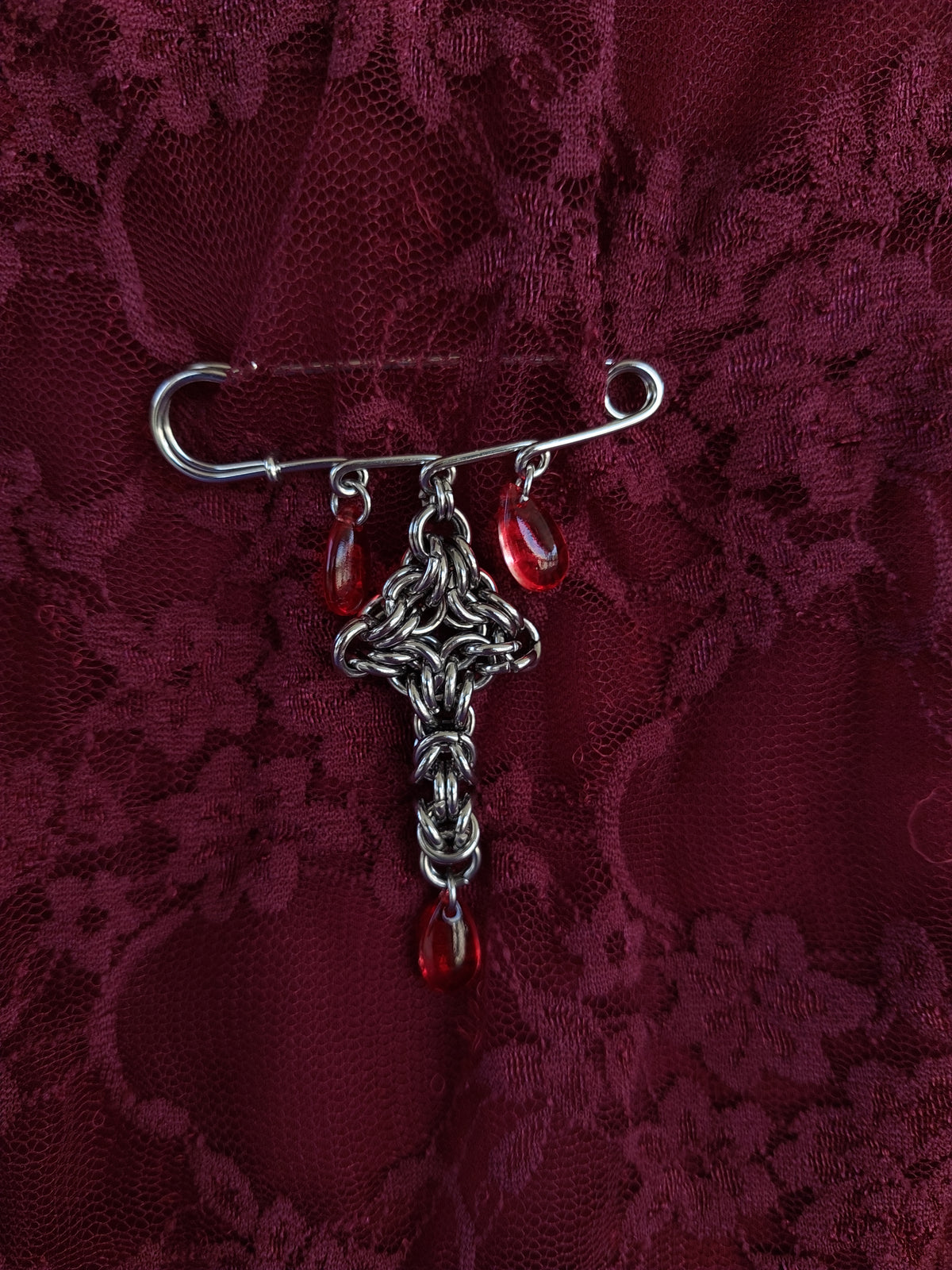 Bleeding cross brooch