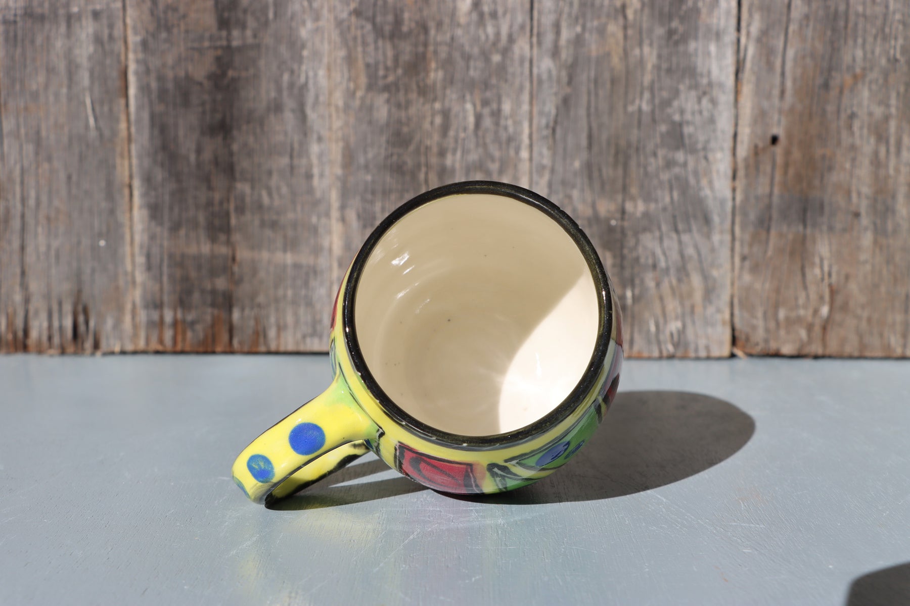 Hand-Painted Mug: Abstract yellow, red, green, black and blue mid-fire stoneware