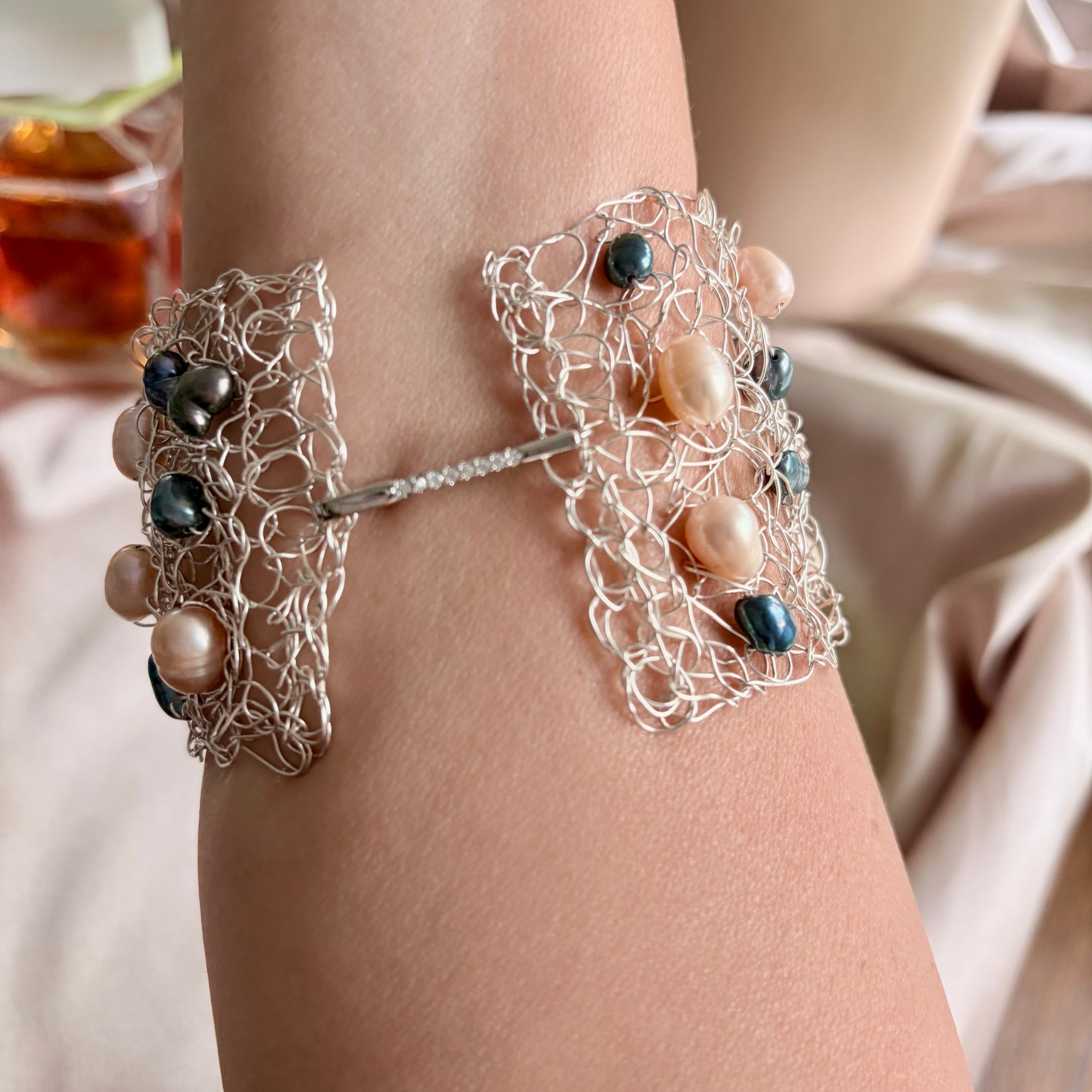 “Pearls Dance” — Peach and dark blue pearls cuff