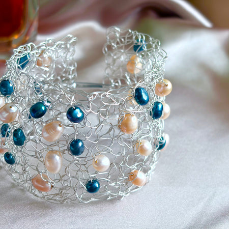 “Pearls Dance” — Peach and dark blue pearls cuff