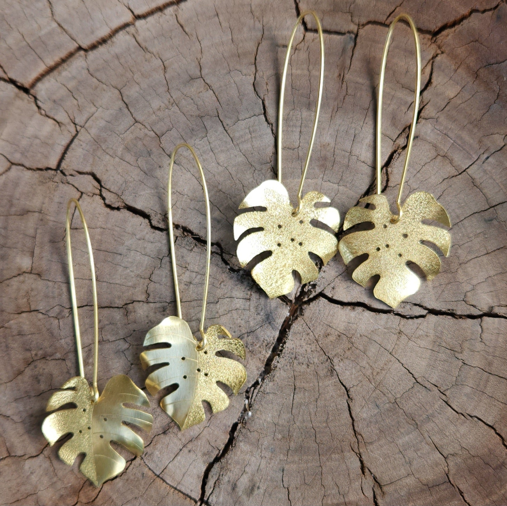 Golden tone monstera earrings