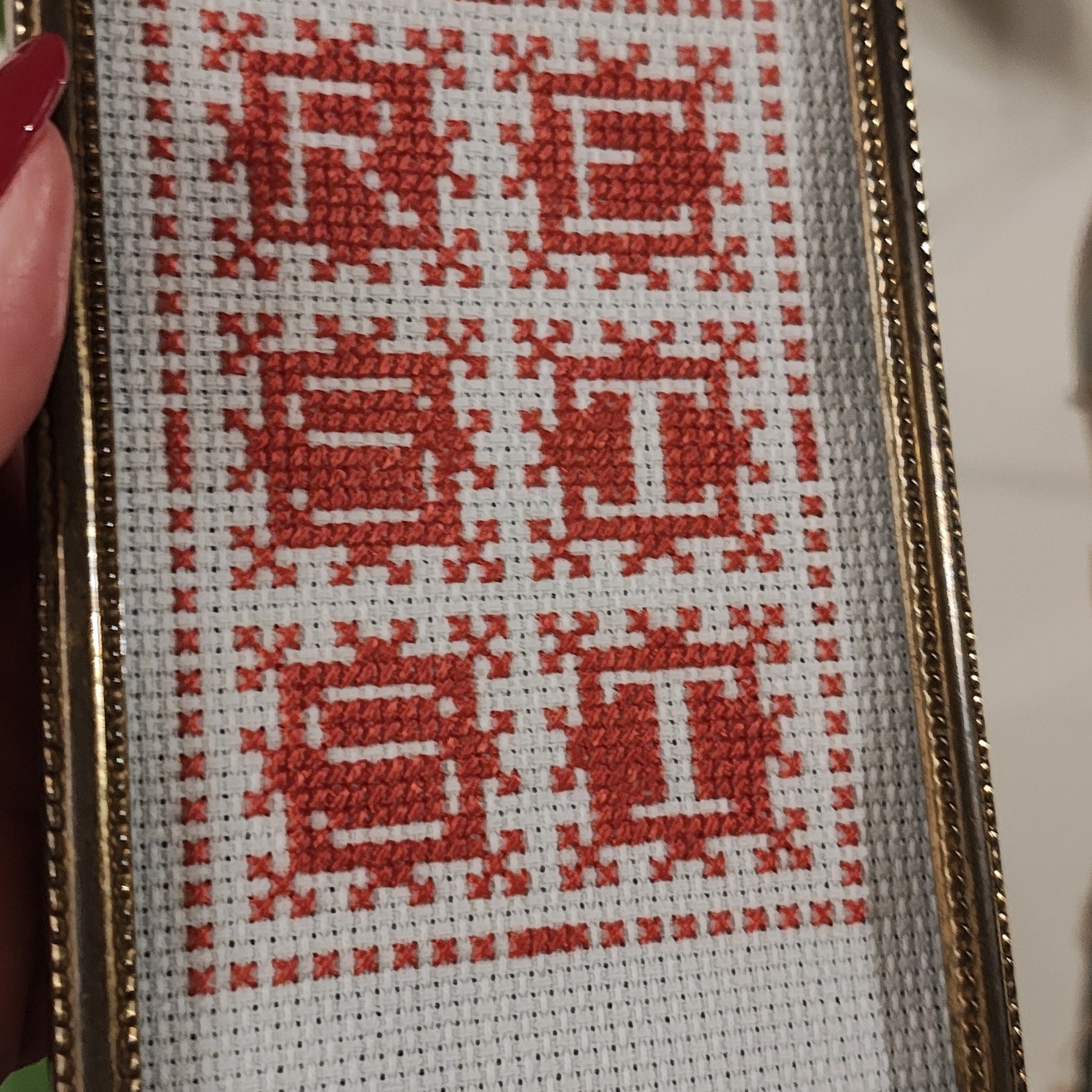 "RESIST" framed cross-stitch