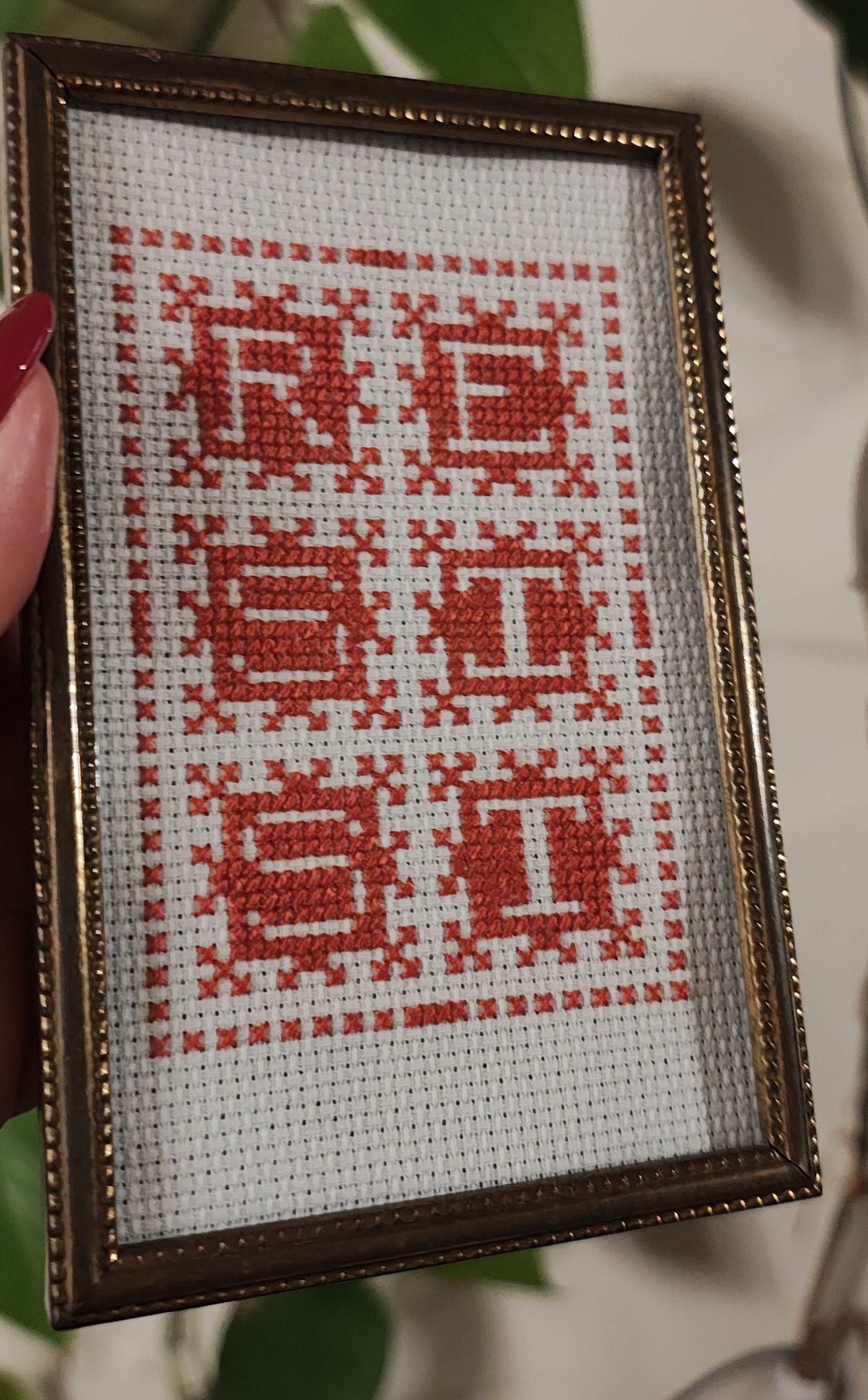 "RESIST" framed cross-stitch