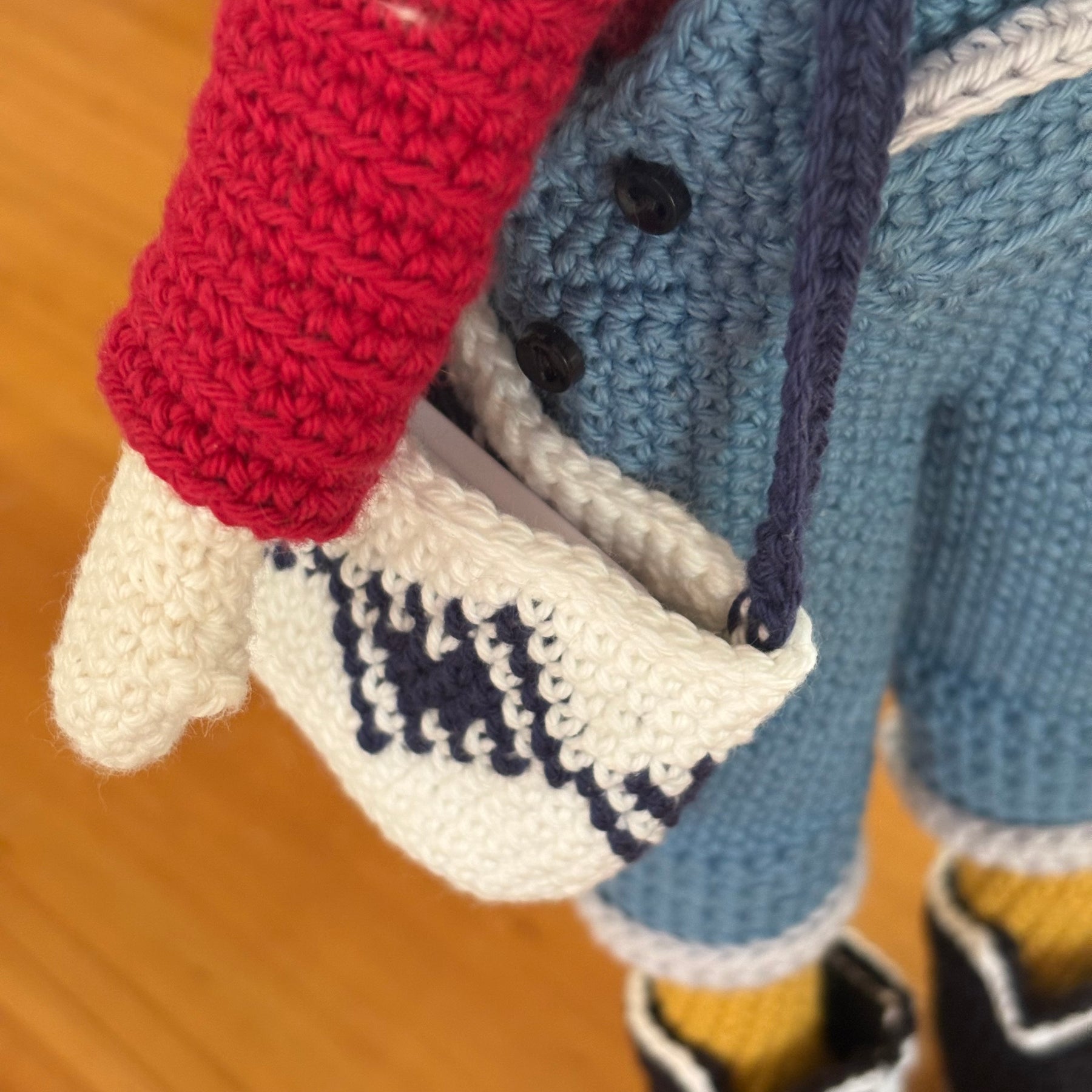 Crochet doll in overalls and beanie.