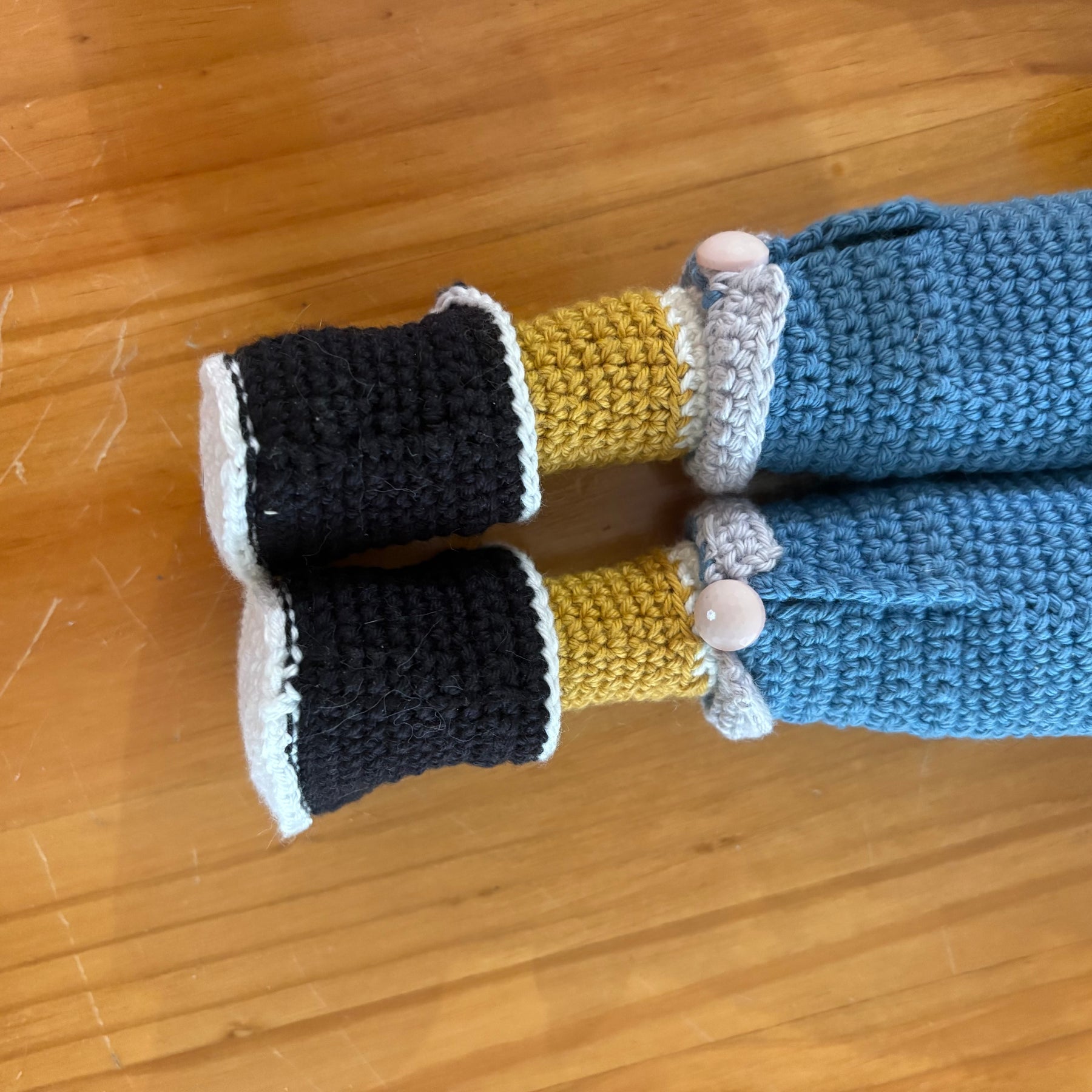 Crochet doll in overalls and beanie.