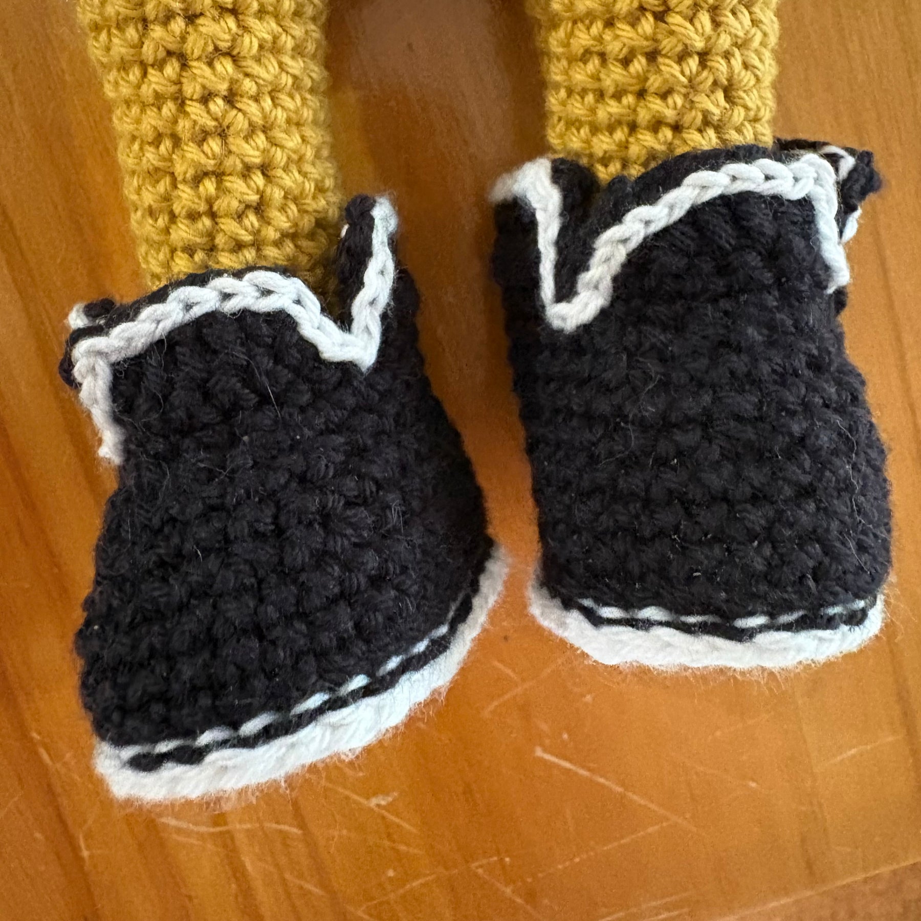 Crochet doll in overalls and beanie.