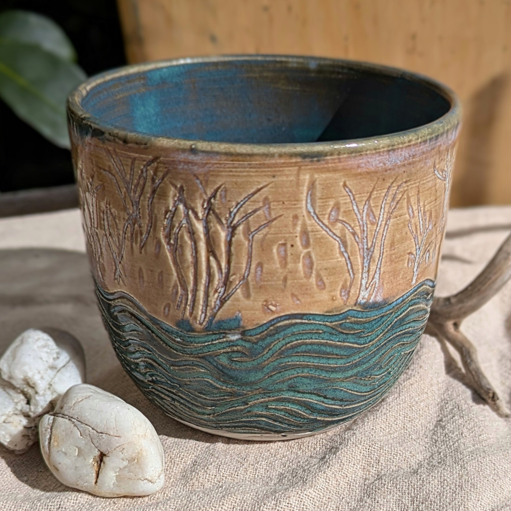 Sand dunes reeds and water tumbler