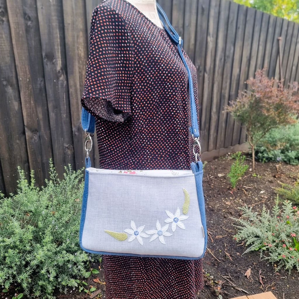 Handmade appliqued crossbody zip bag - blue with flannel flowers