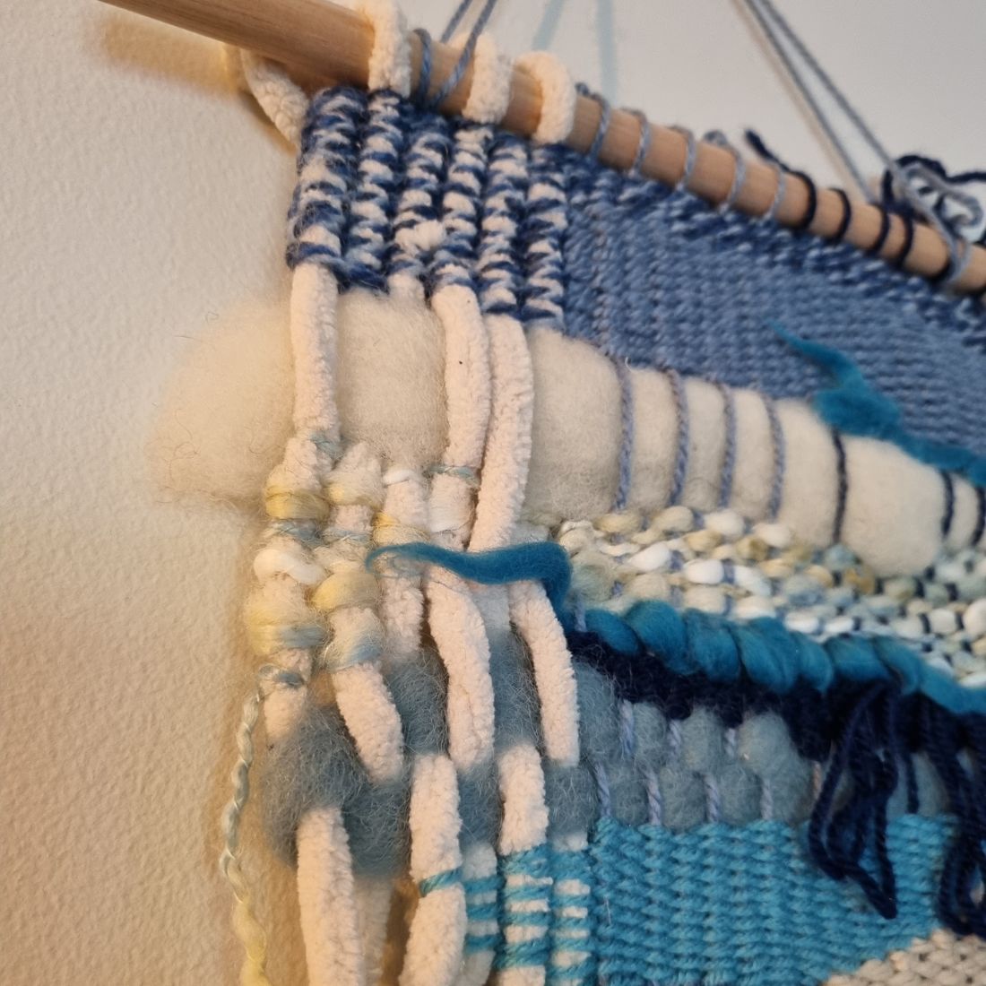 Handwoven wall hanging in blue and cream