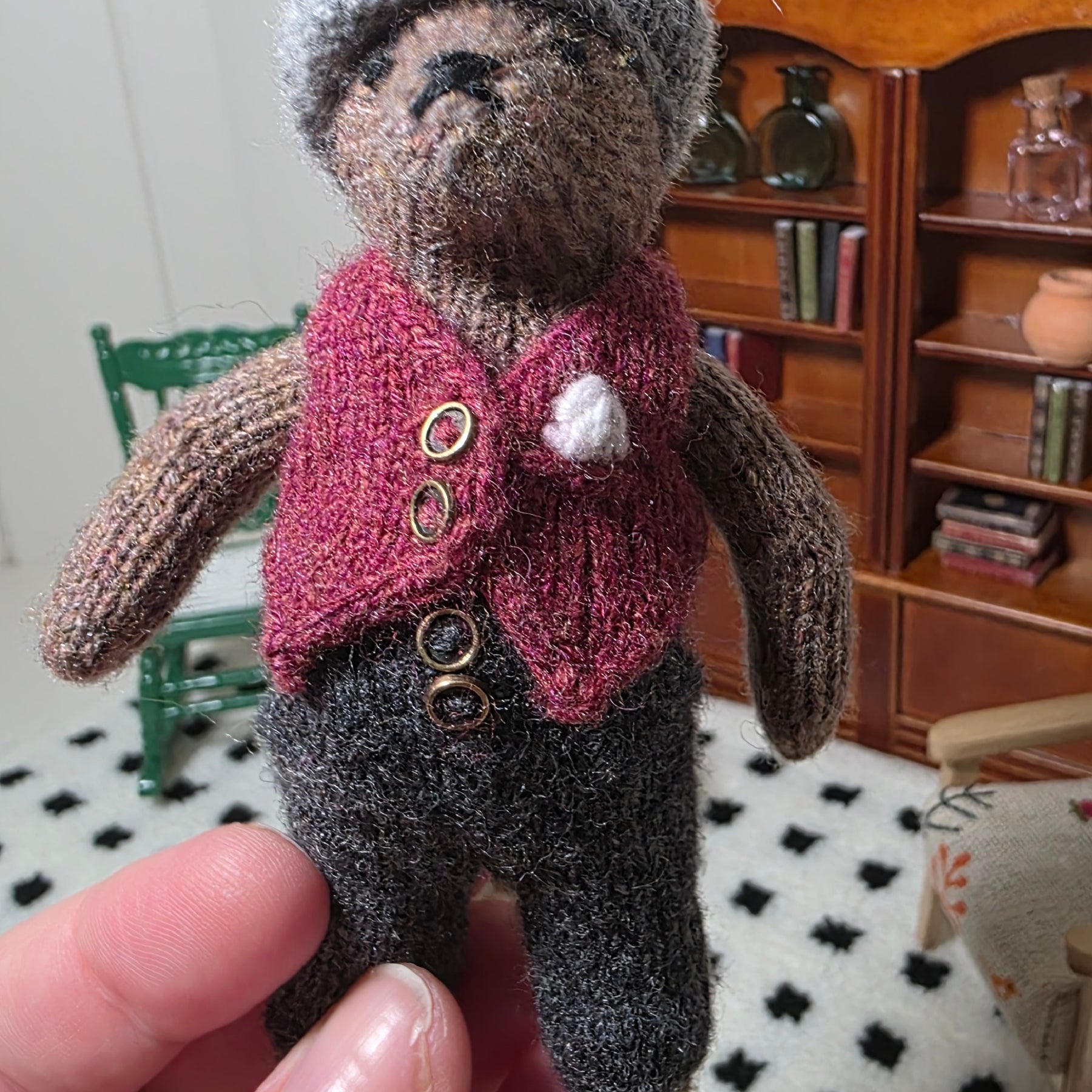 Small hand knitted bear with removeable clothes