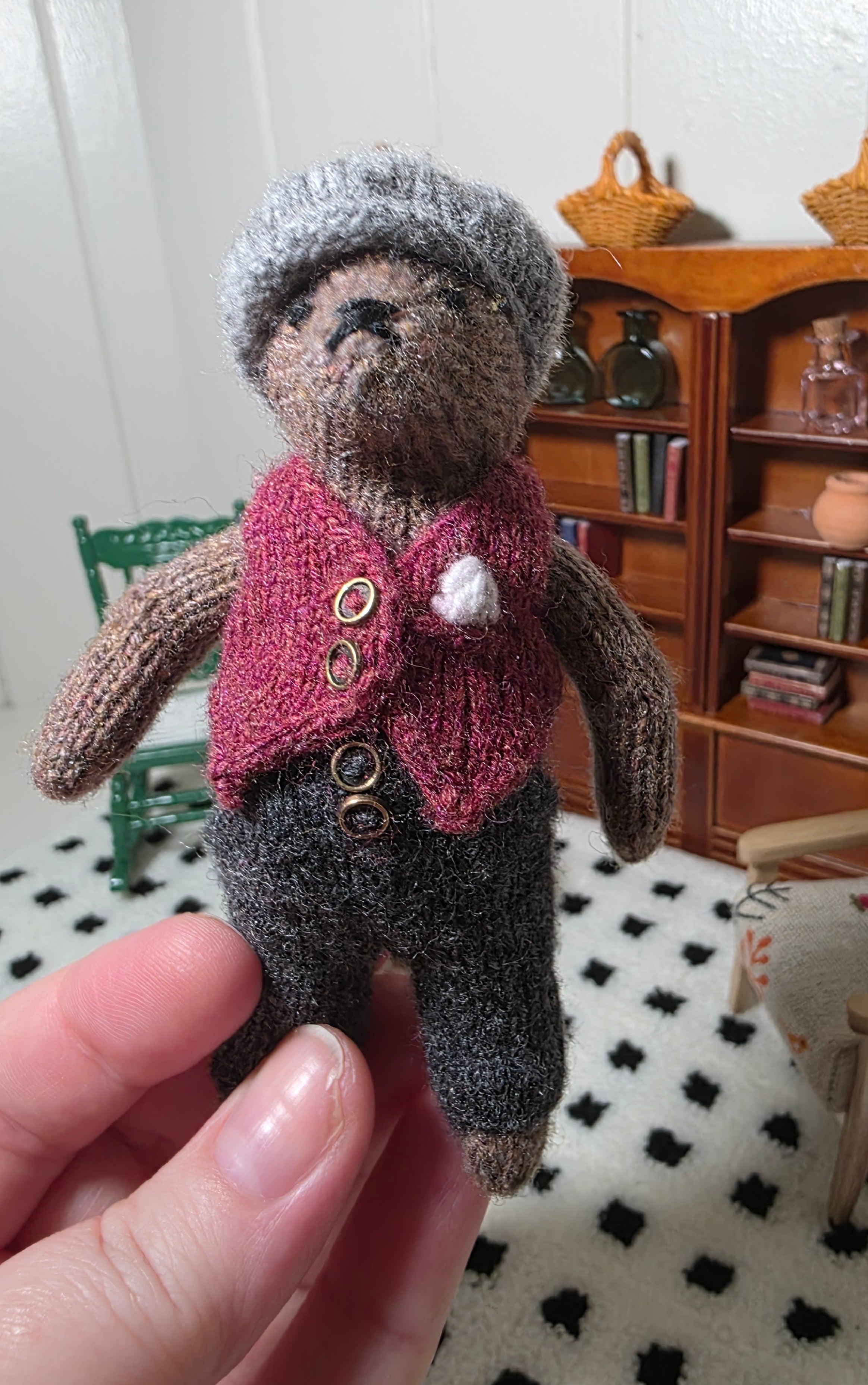 Small hand knitted bear with removeable clothes