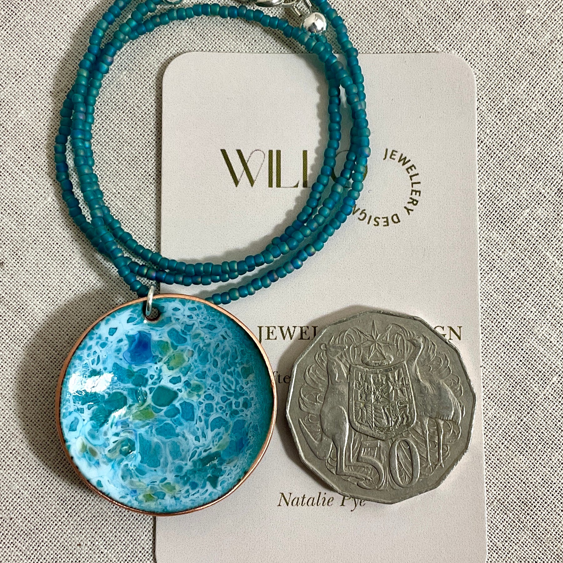 Blue and green enamel pendant on glass seed beads