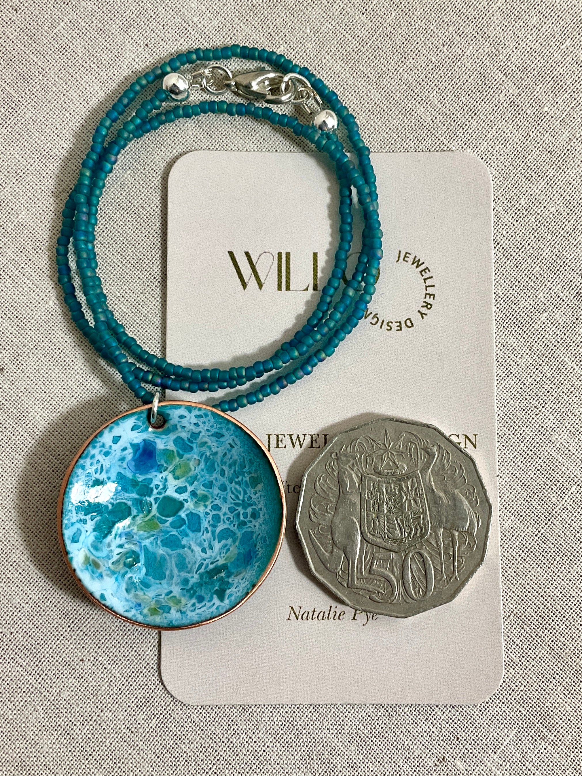 Blue and green enamel pendant on glass seed beads