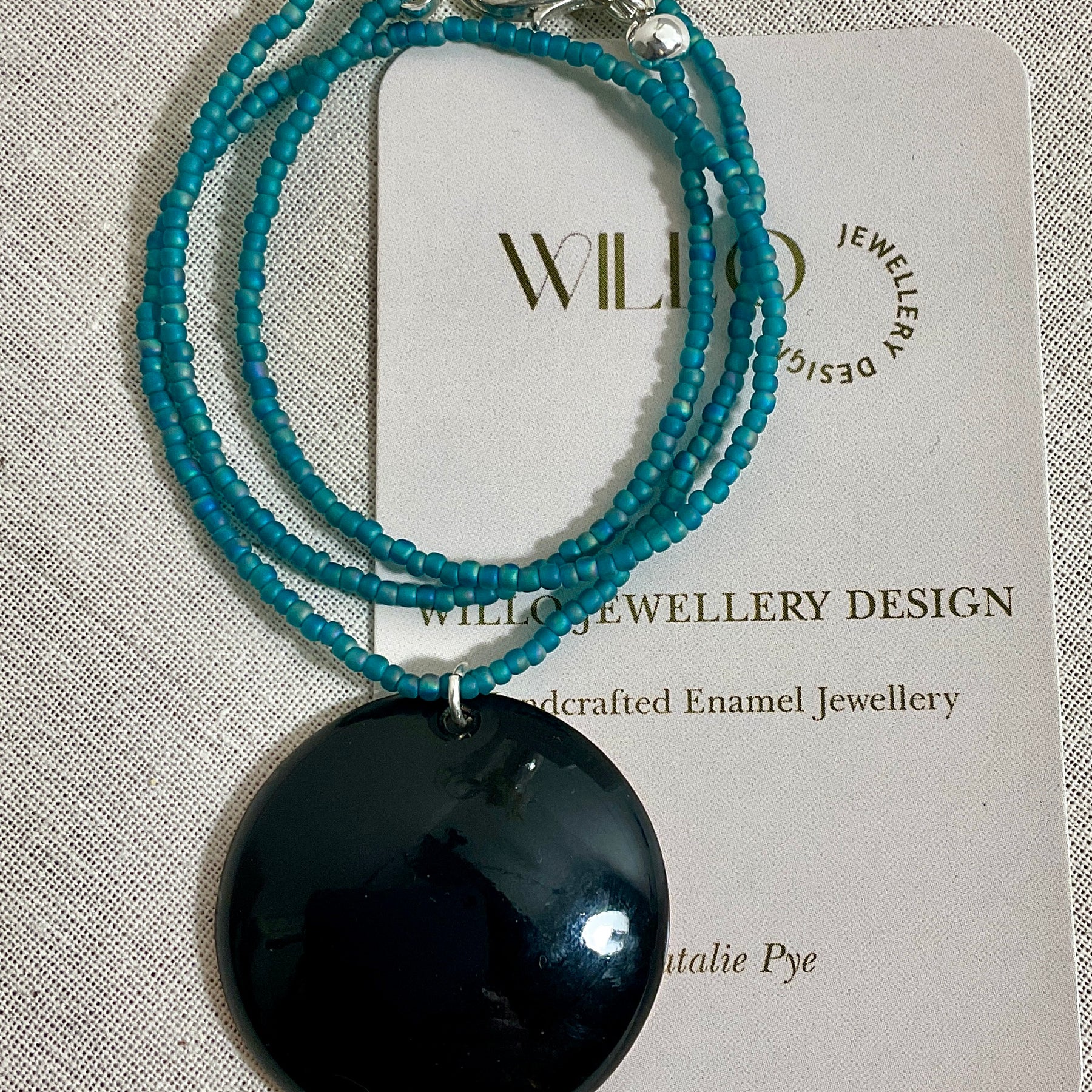 Blue and green enamel pendant on glass seed beads