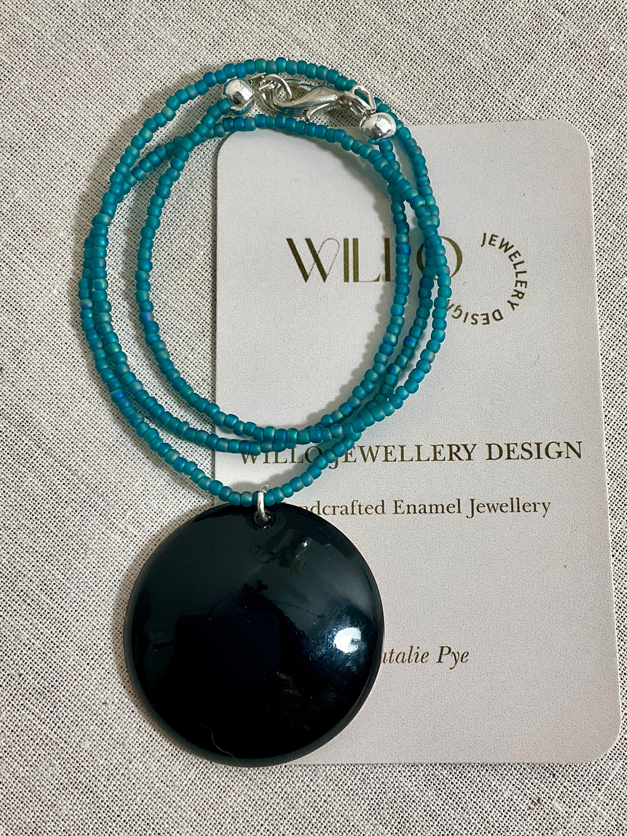 Blue and green enamel pendant on glass seed beads