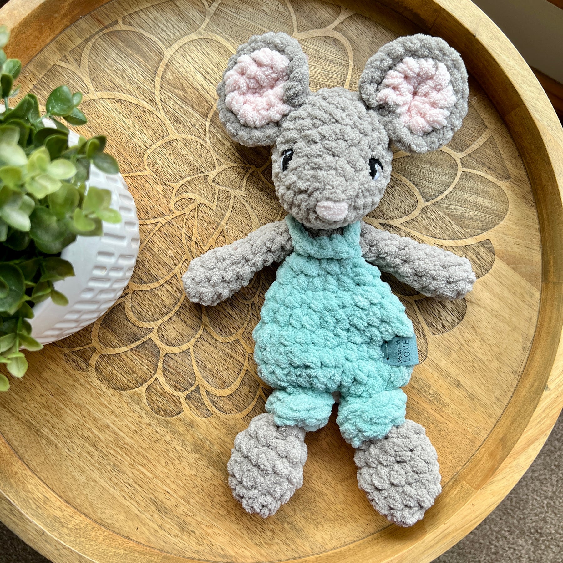 Handmade crochet Mini Mouse modern lovey in overalls with knotted legs.