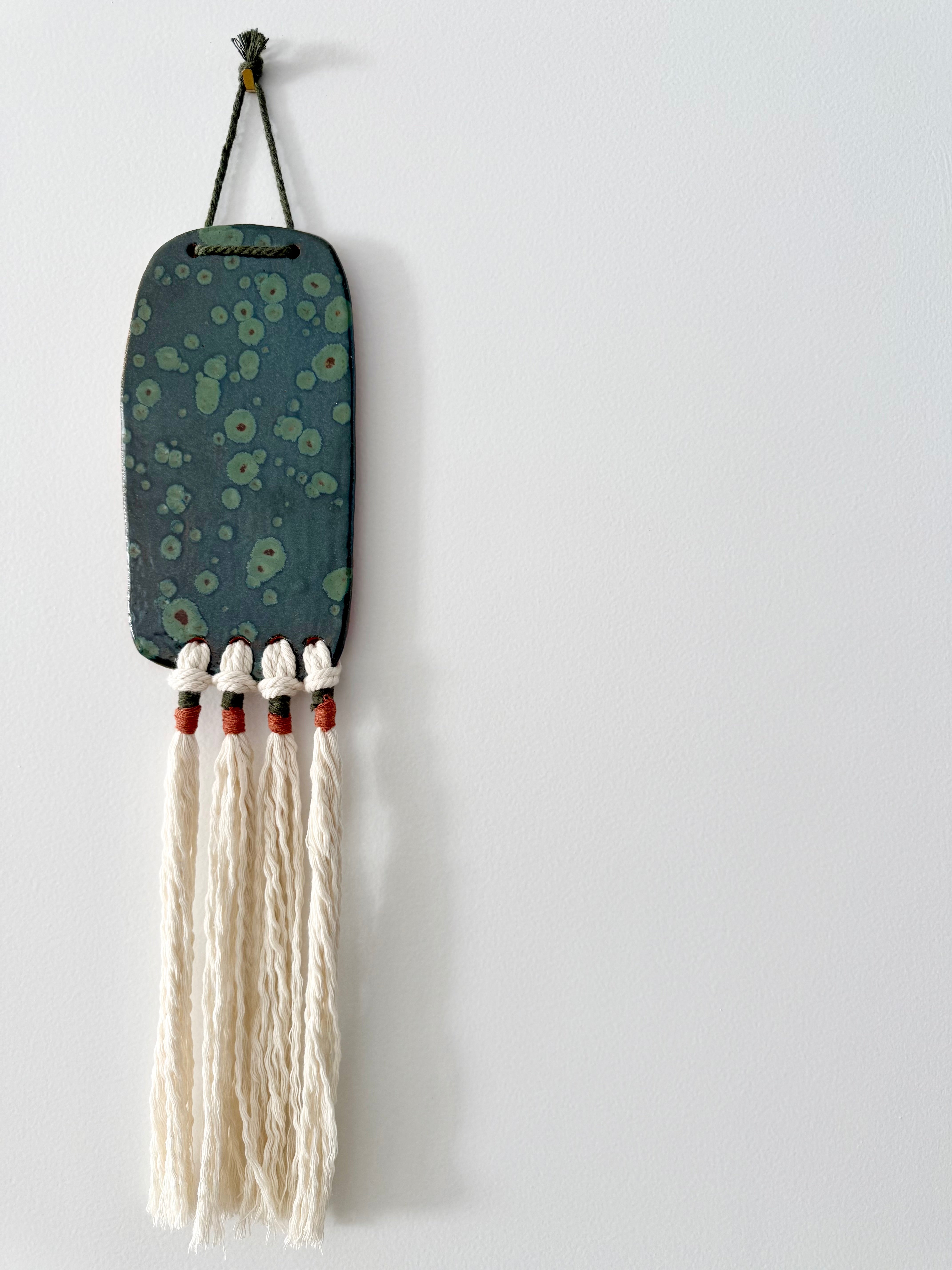 Clay and cord wall hanging