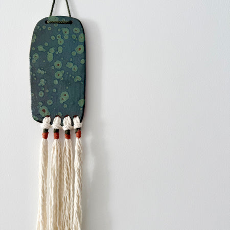 Clay and cord wall hanging