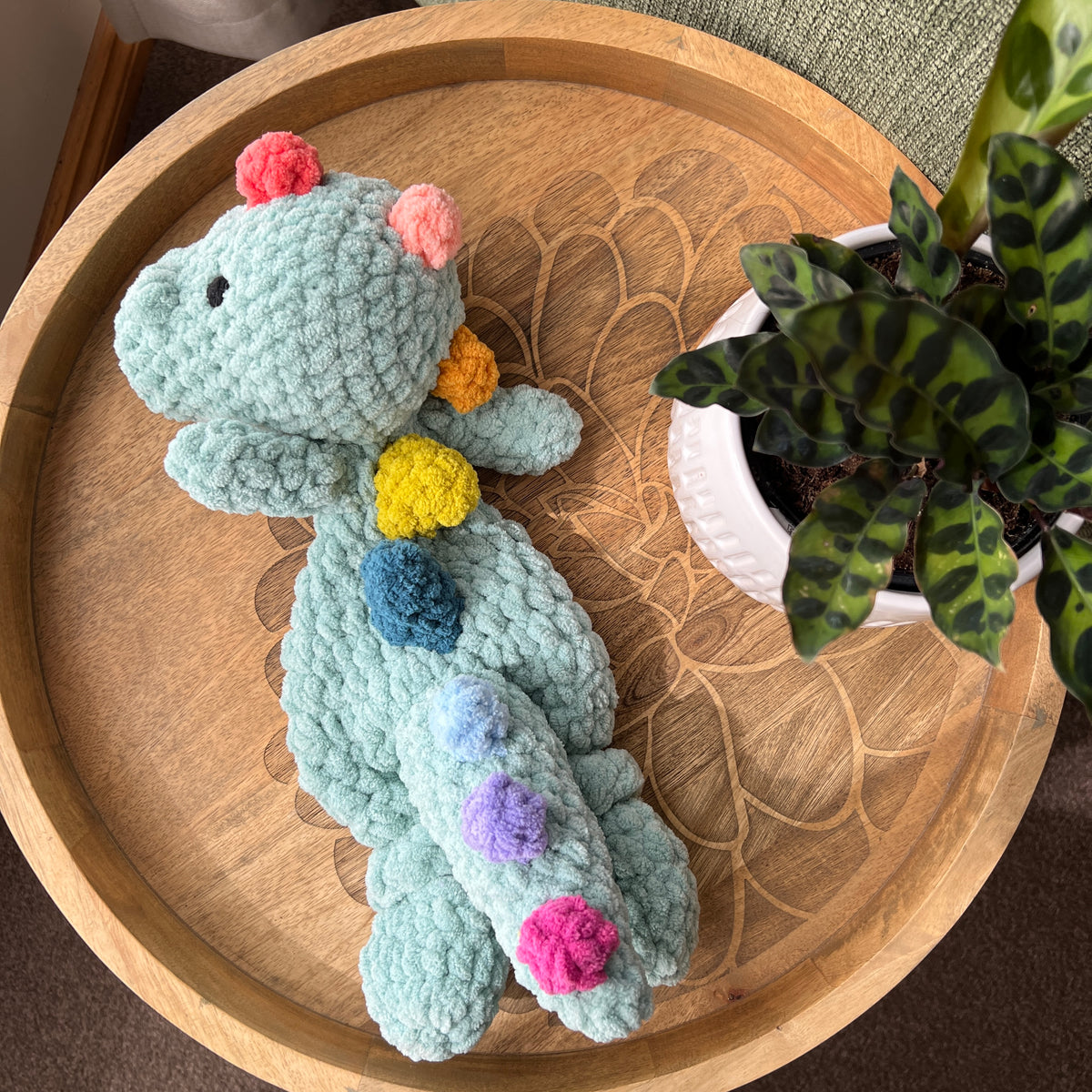 (Copy) Handmade crochet Dinosaur modern lovey snuggler with knotted legs and rainbow spikes.